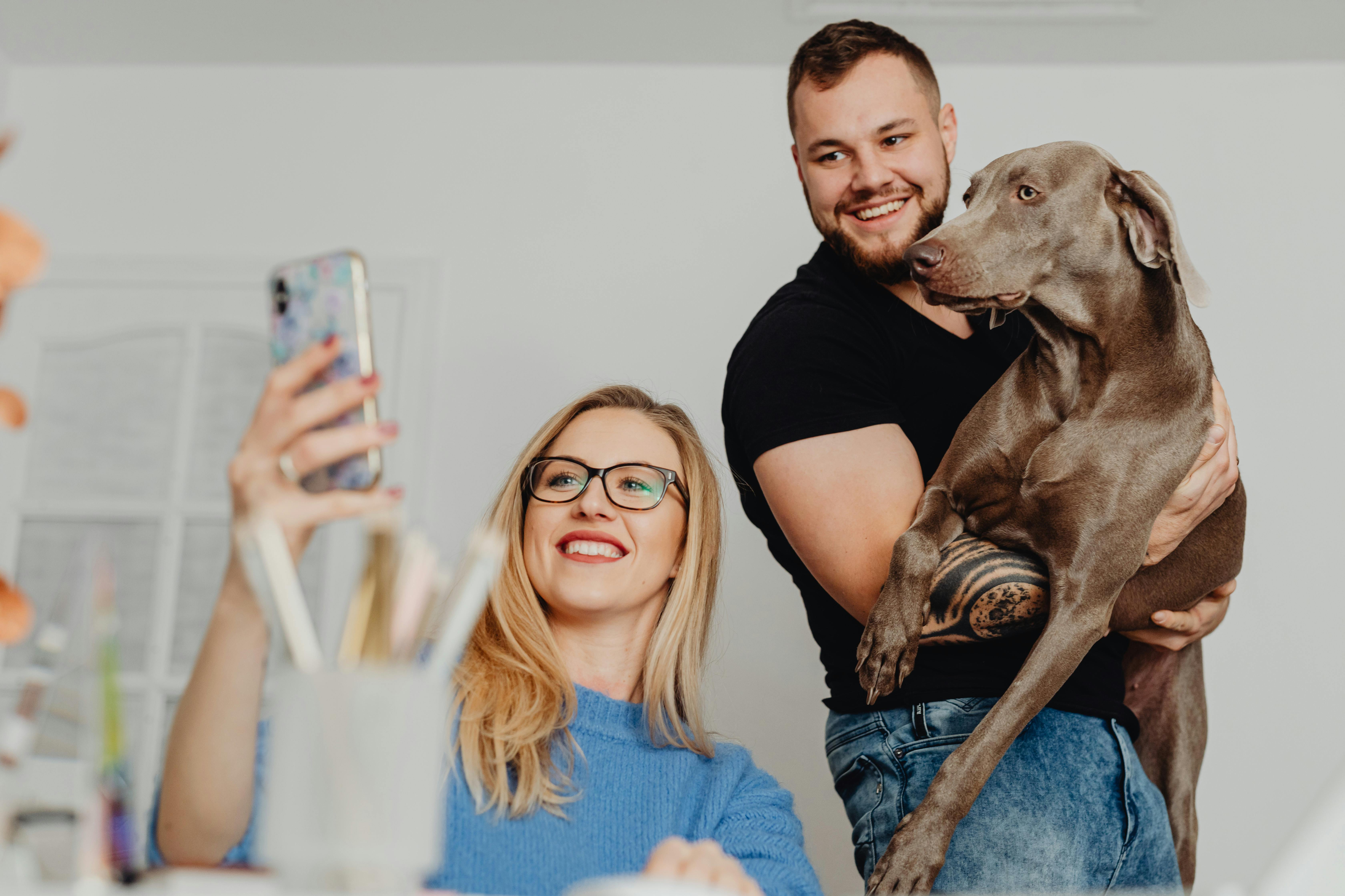 Couple with a Dog Taking Selfie Picture