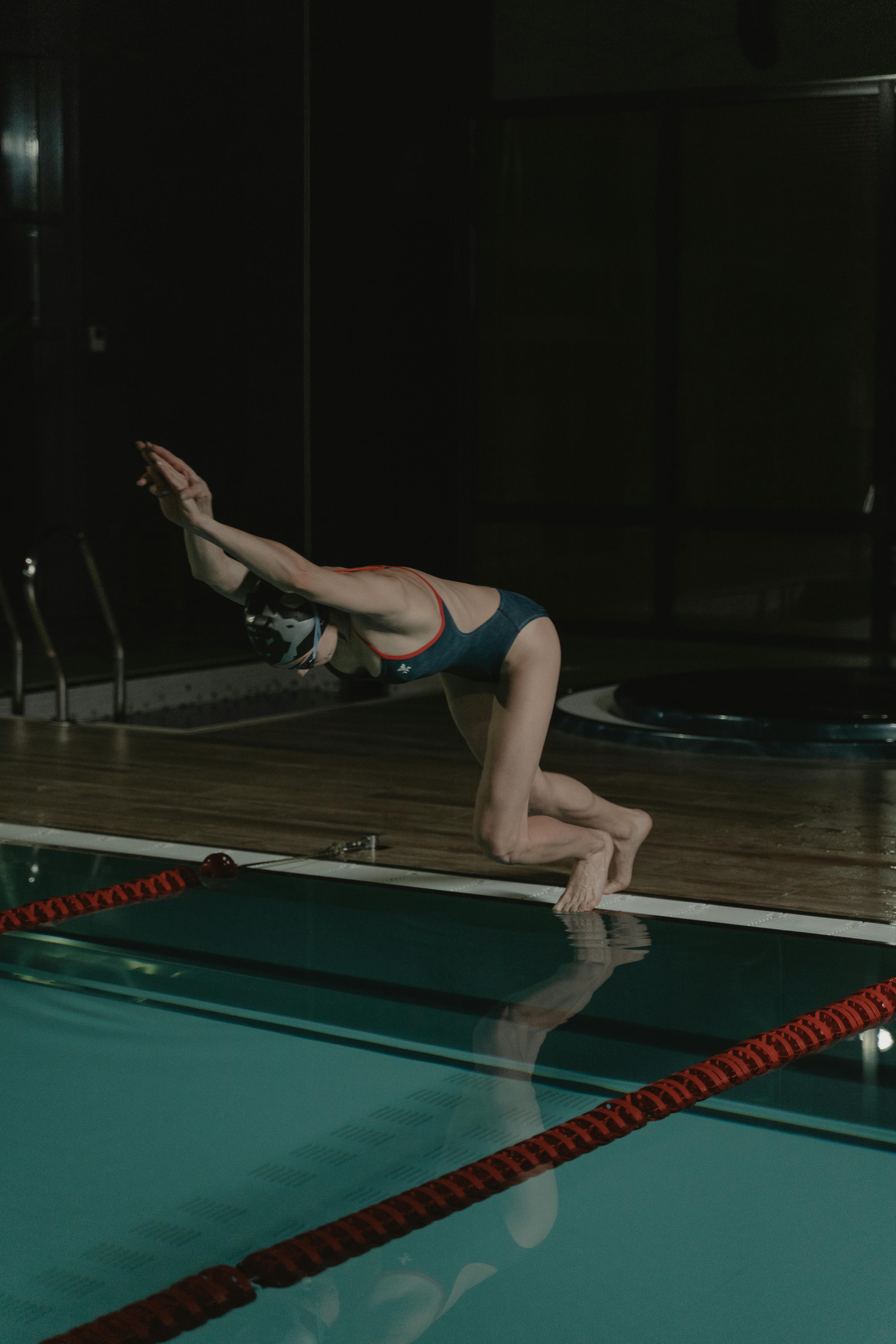 A Woman Diving on the Swimming Pool