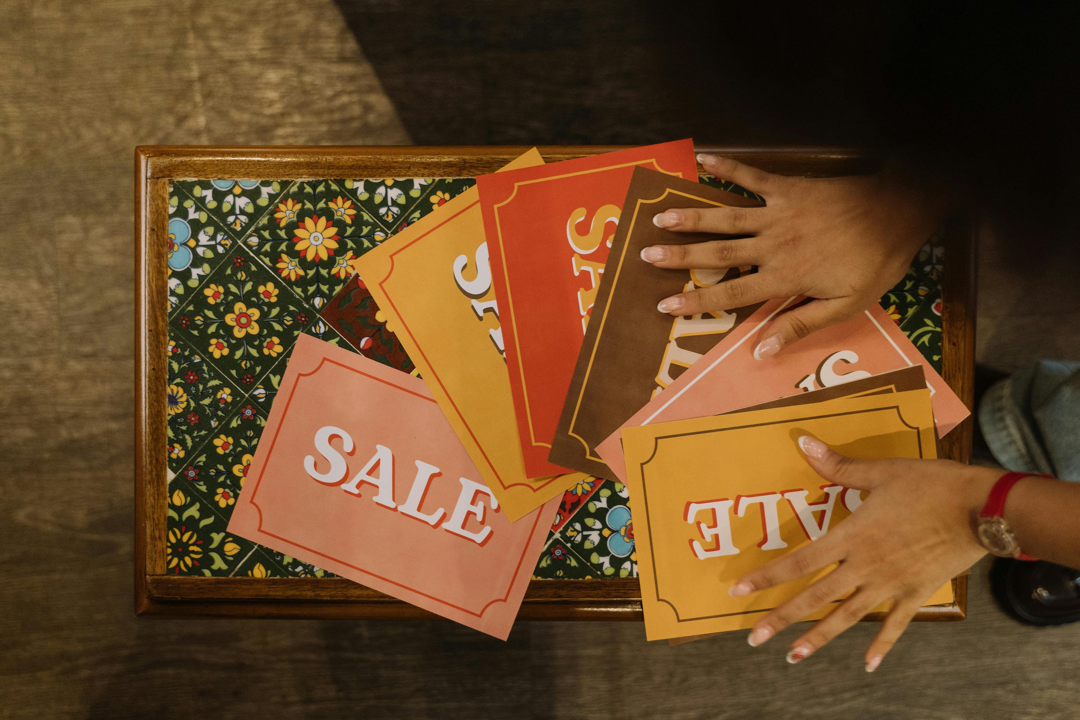 Top View of a Person Touching a Set of Sale Signs