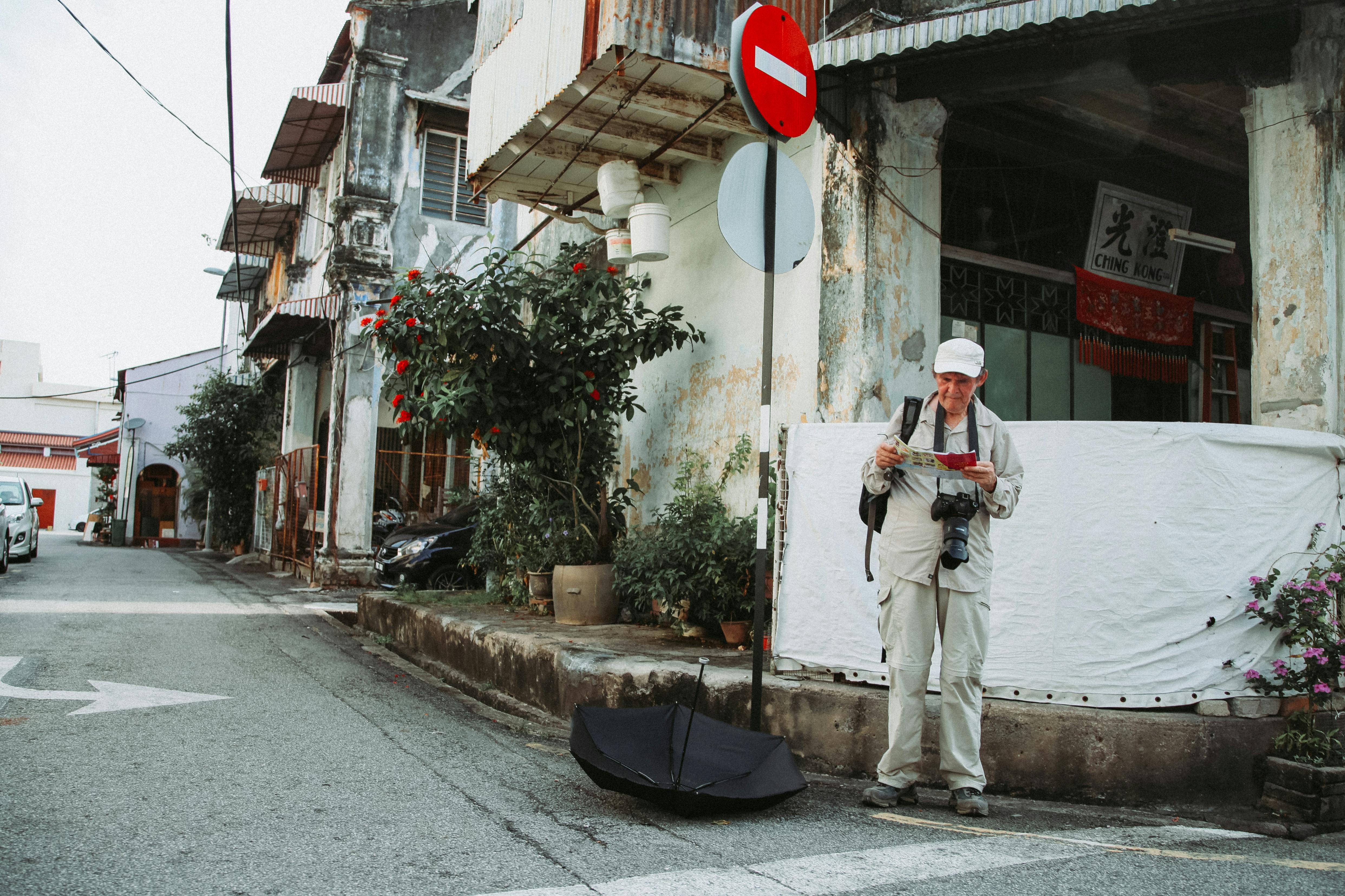 Elderly traveler with photo camera on street