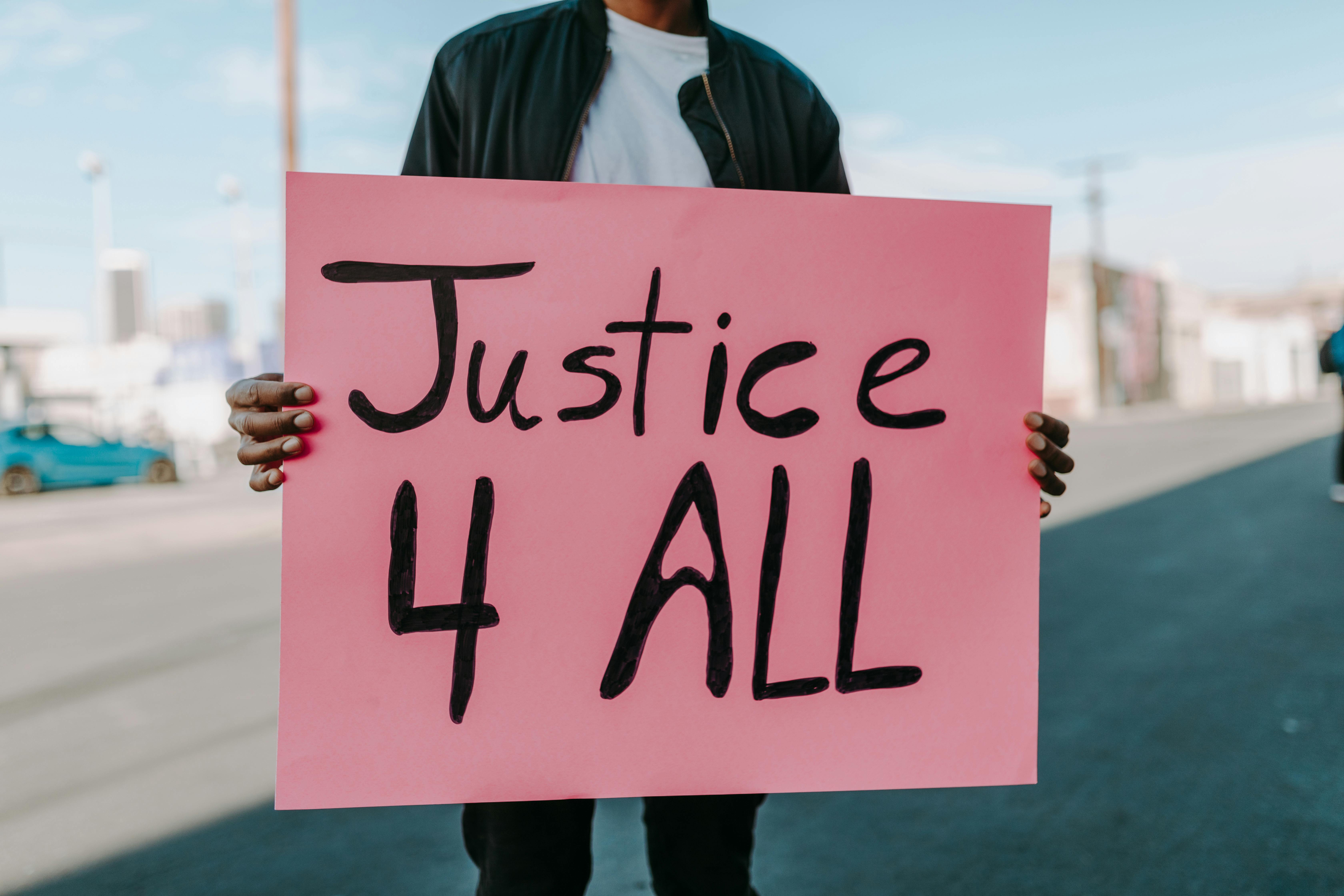 A Person Holding a Pink Placard