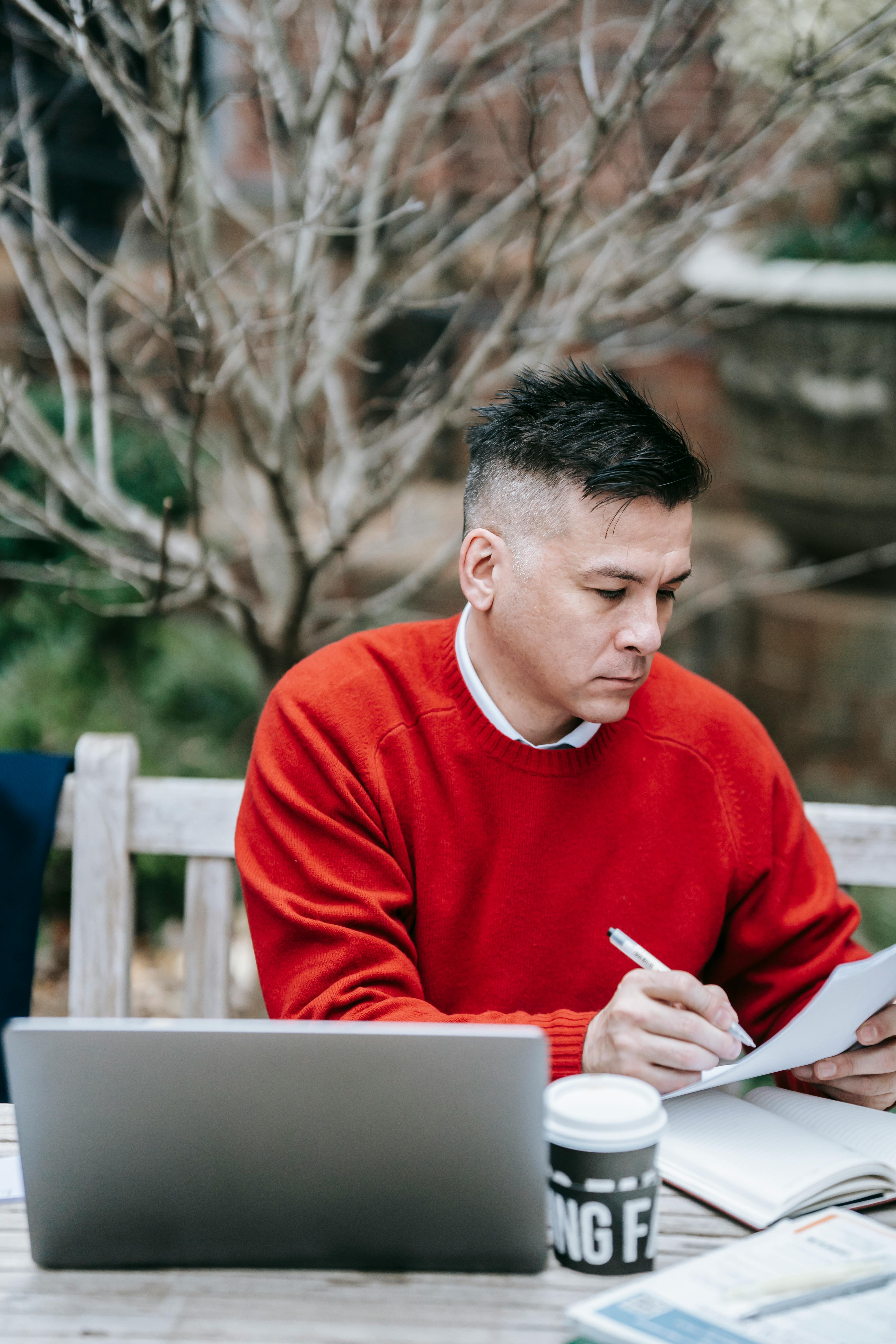 Photo Of Man Looking At Paper