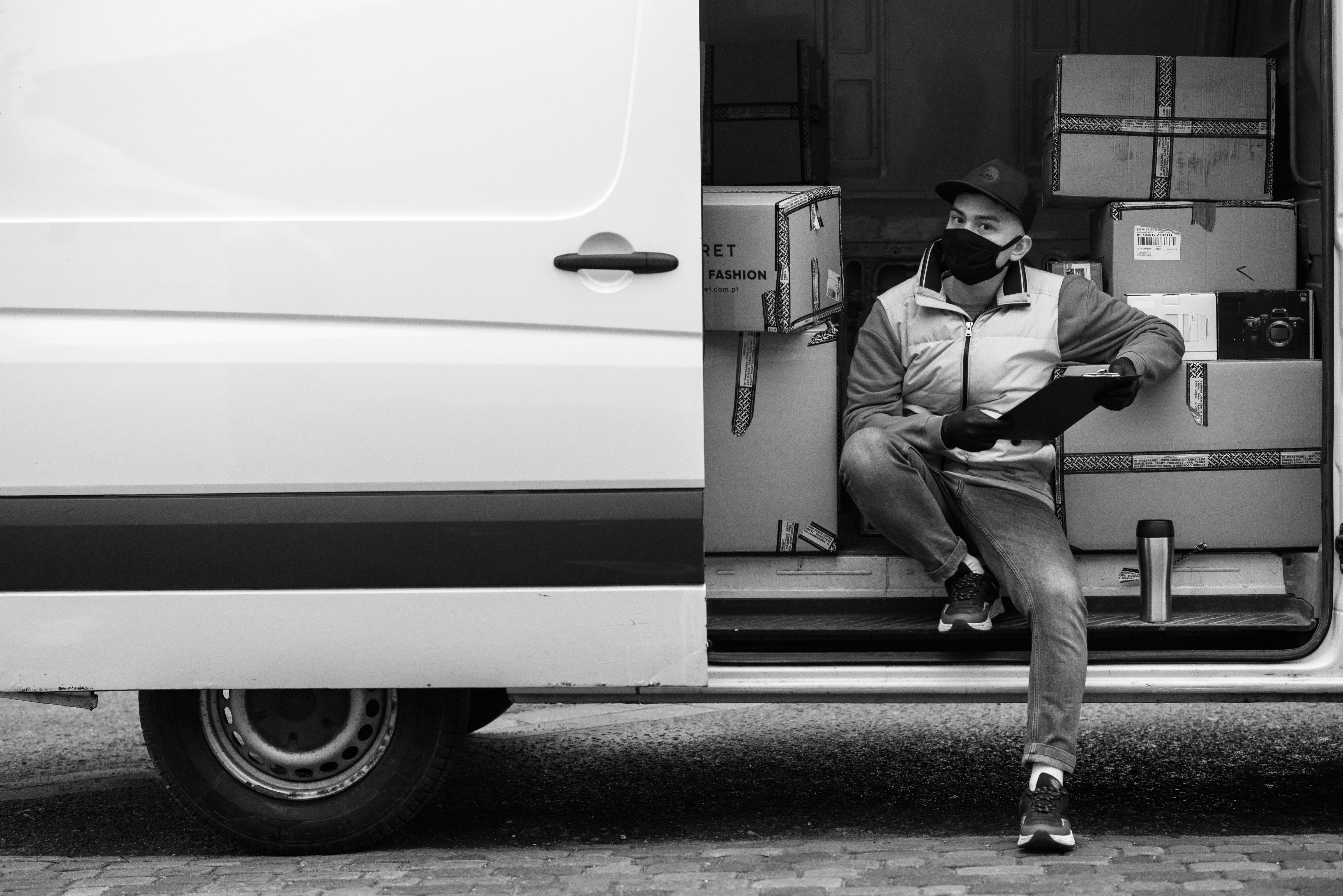 A Deliveryman on the Side of a Van