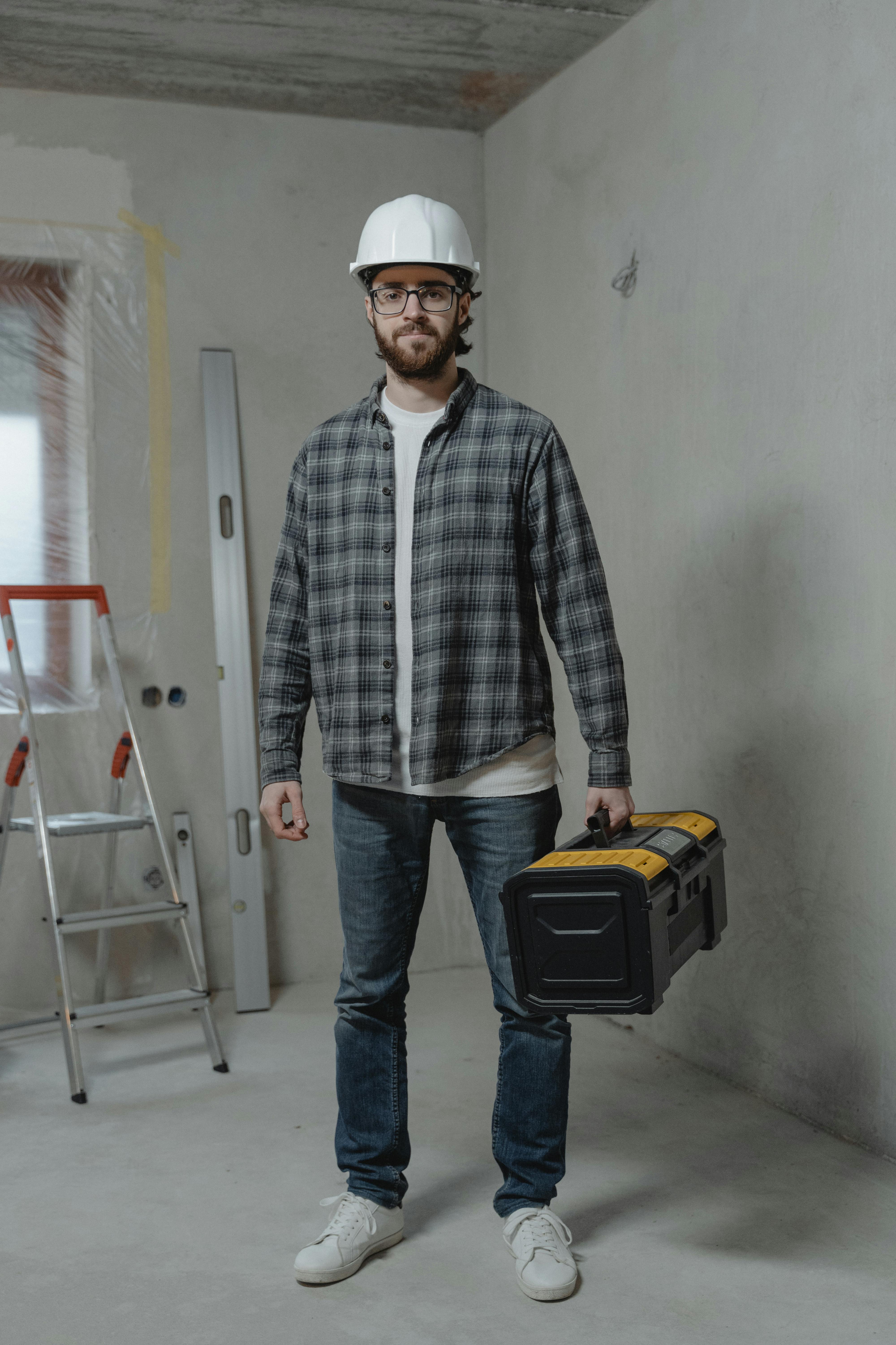 A Man Carrying a Tool Box