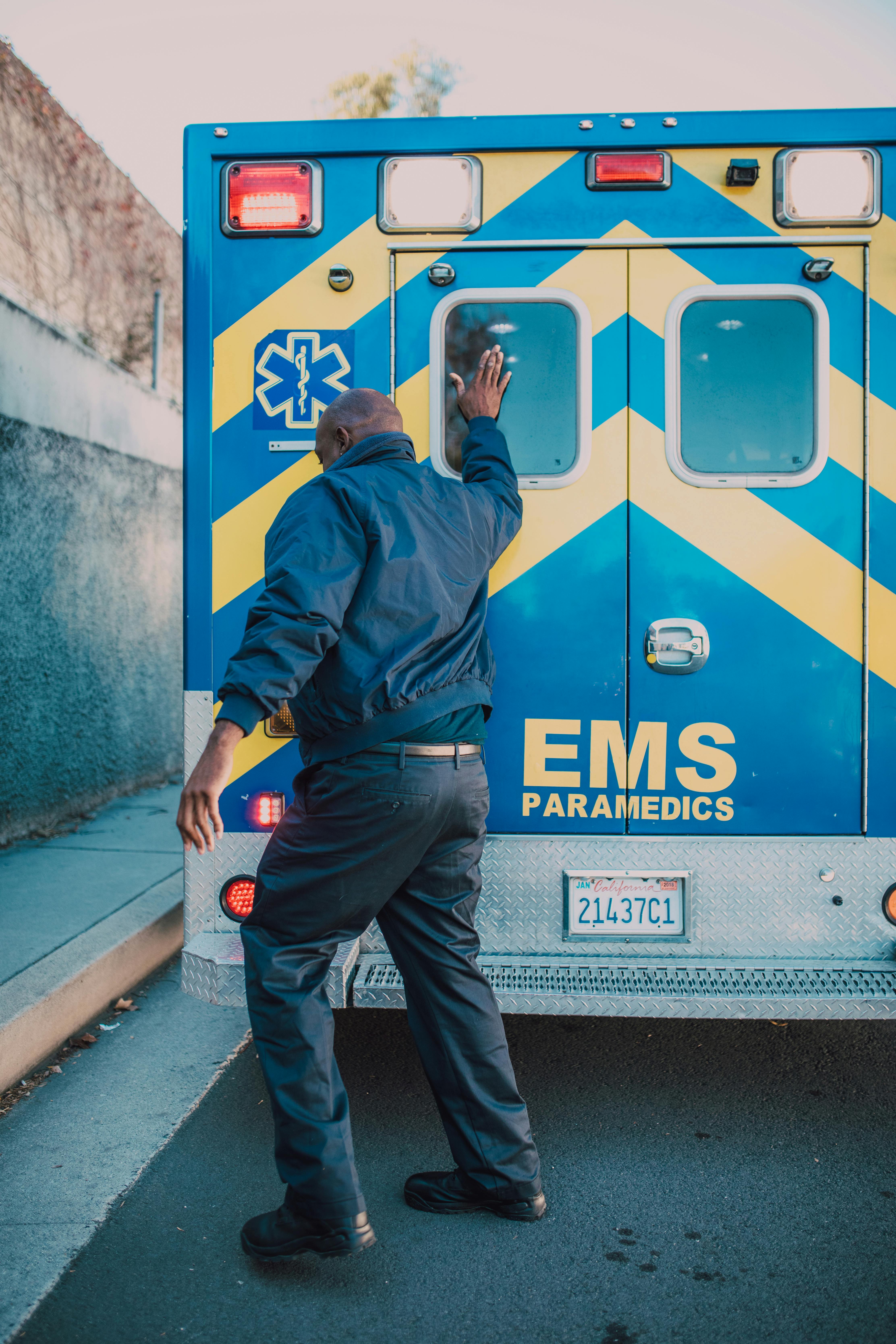 Paramedic Tapping Ambulance Door