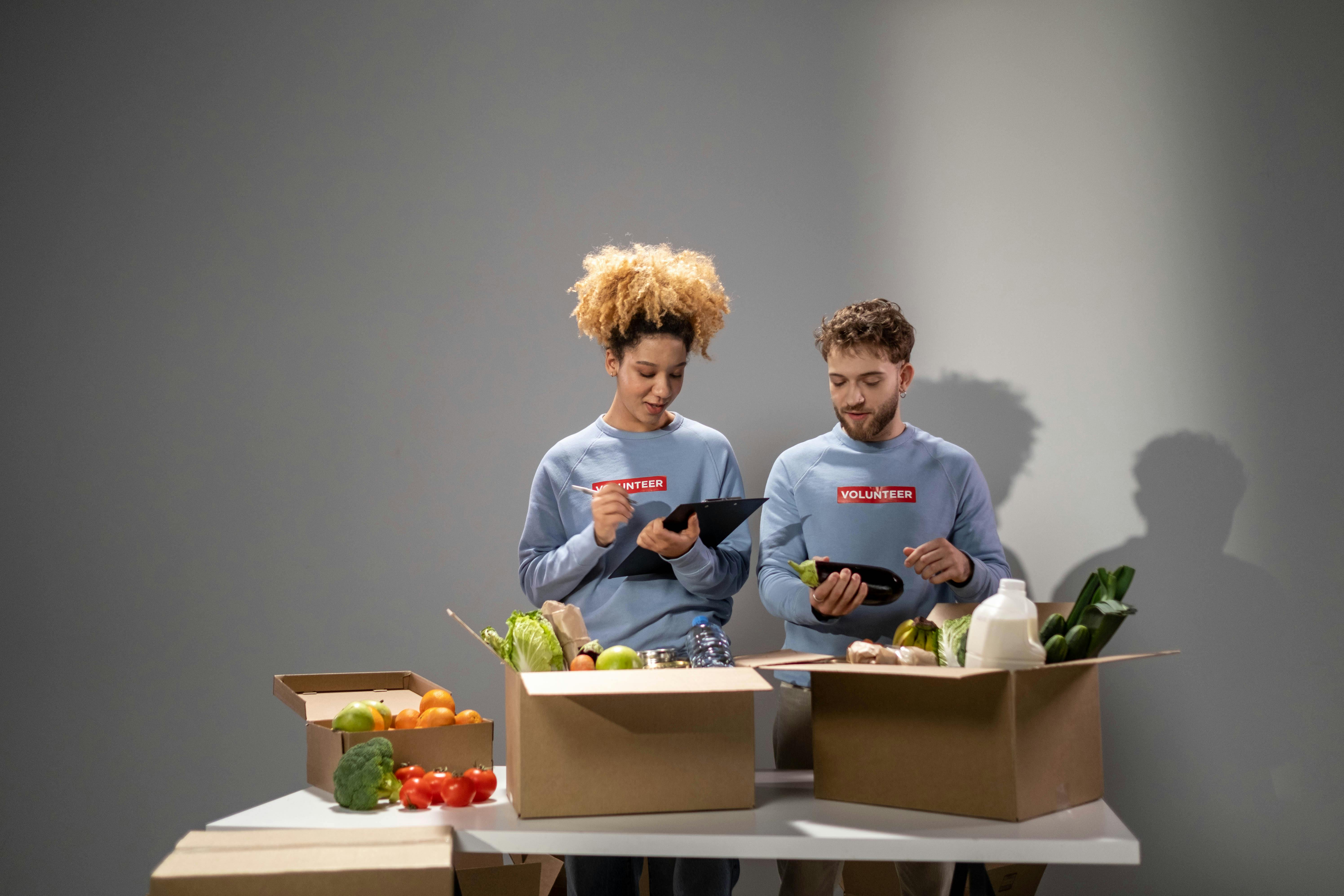 Man in Blue Sweater Holding Eggplant