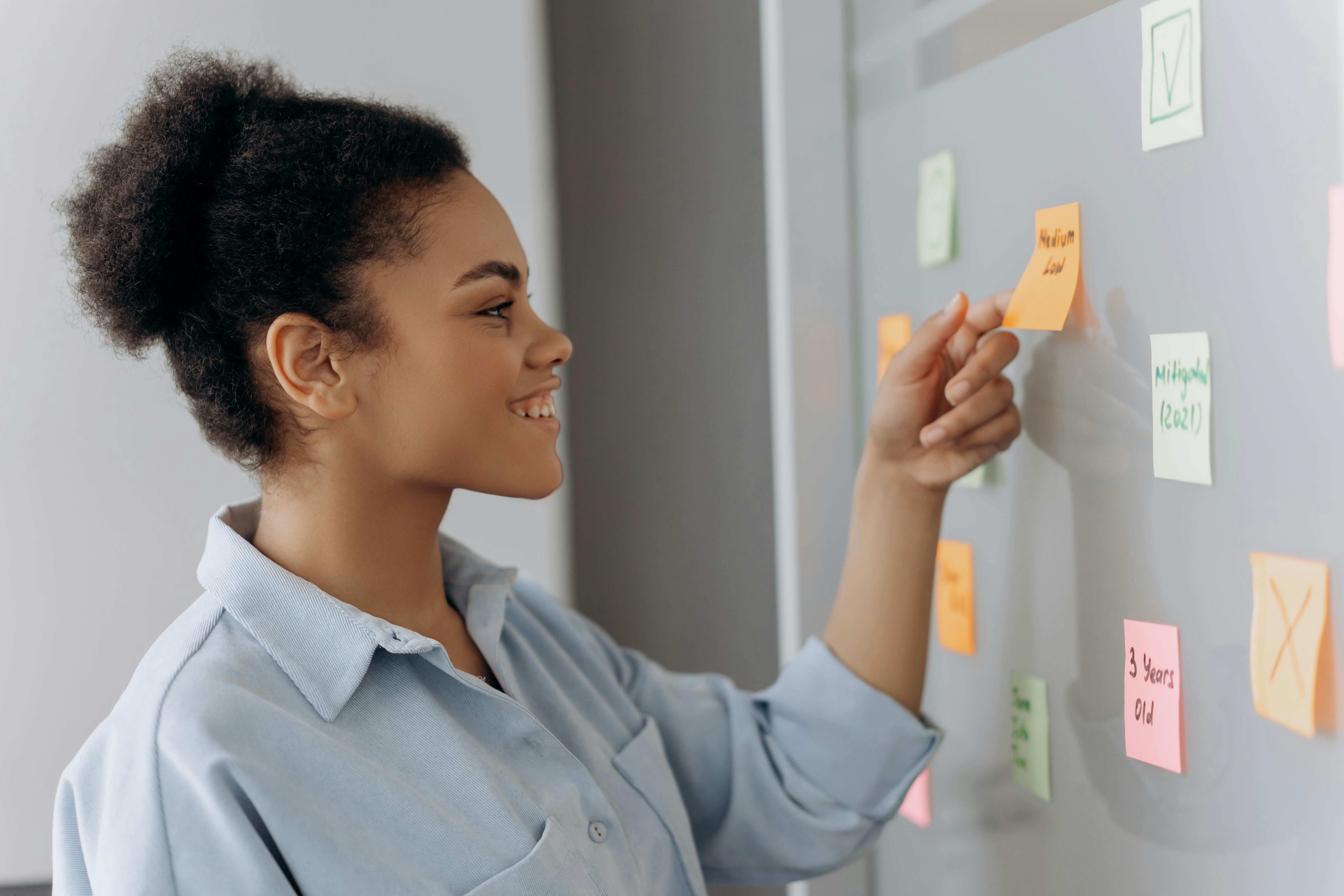 Side View of Woman Holding Orange Sticky Notes