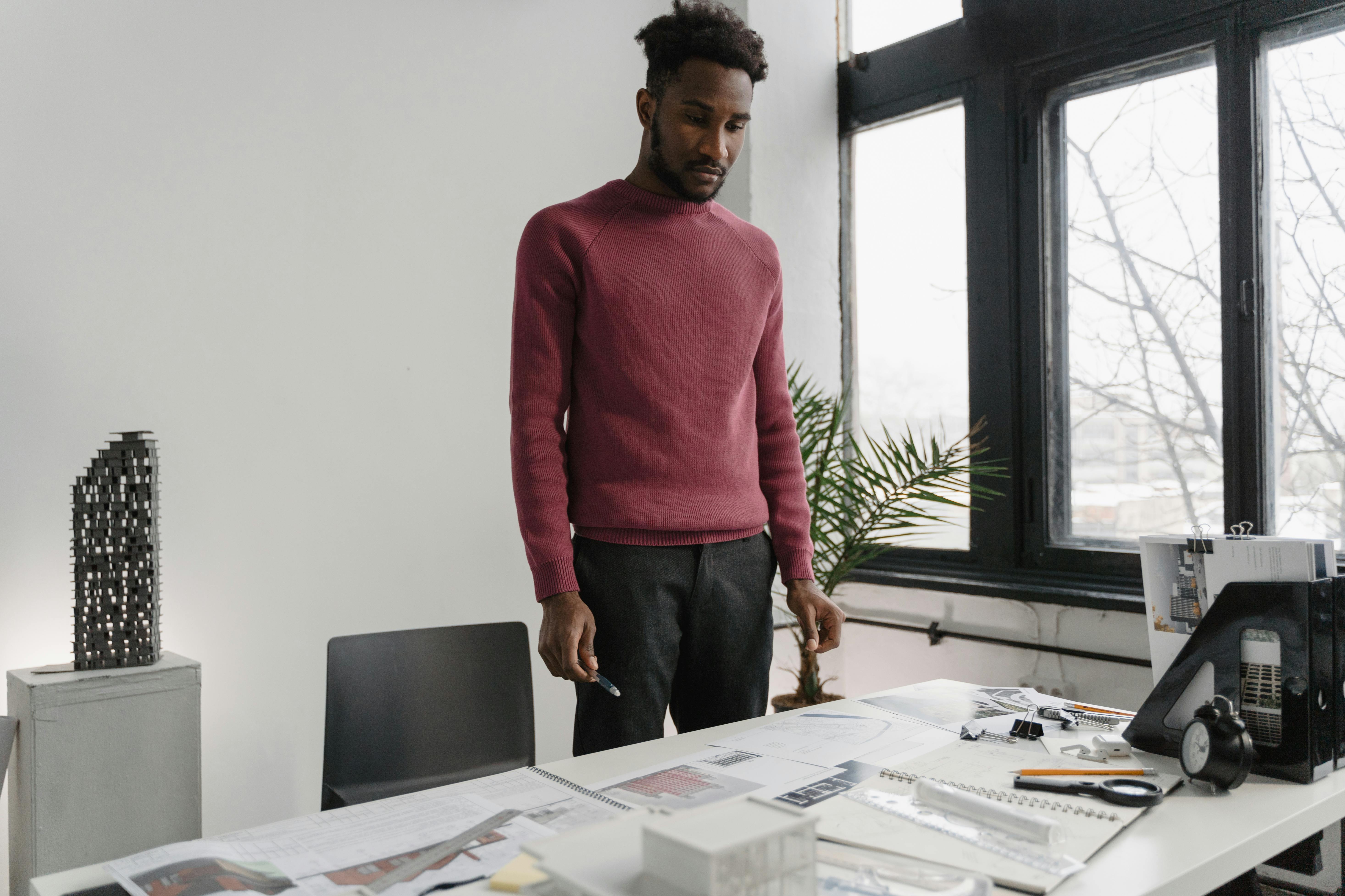 A Man Looking at His Paperworks on Table