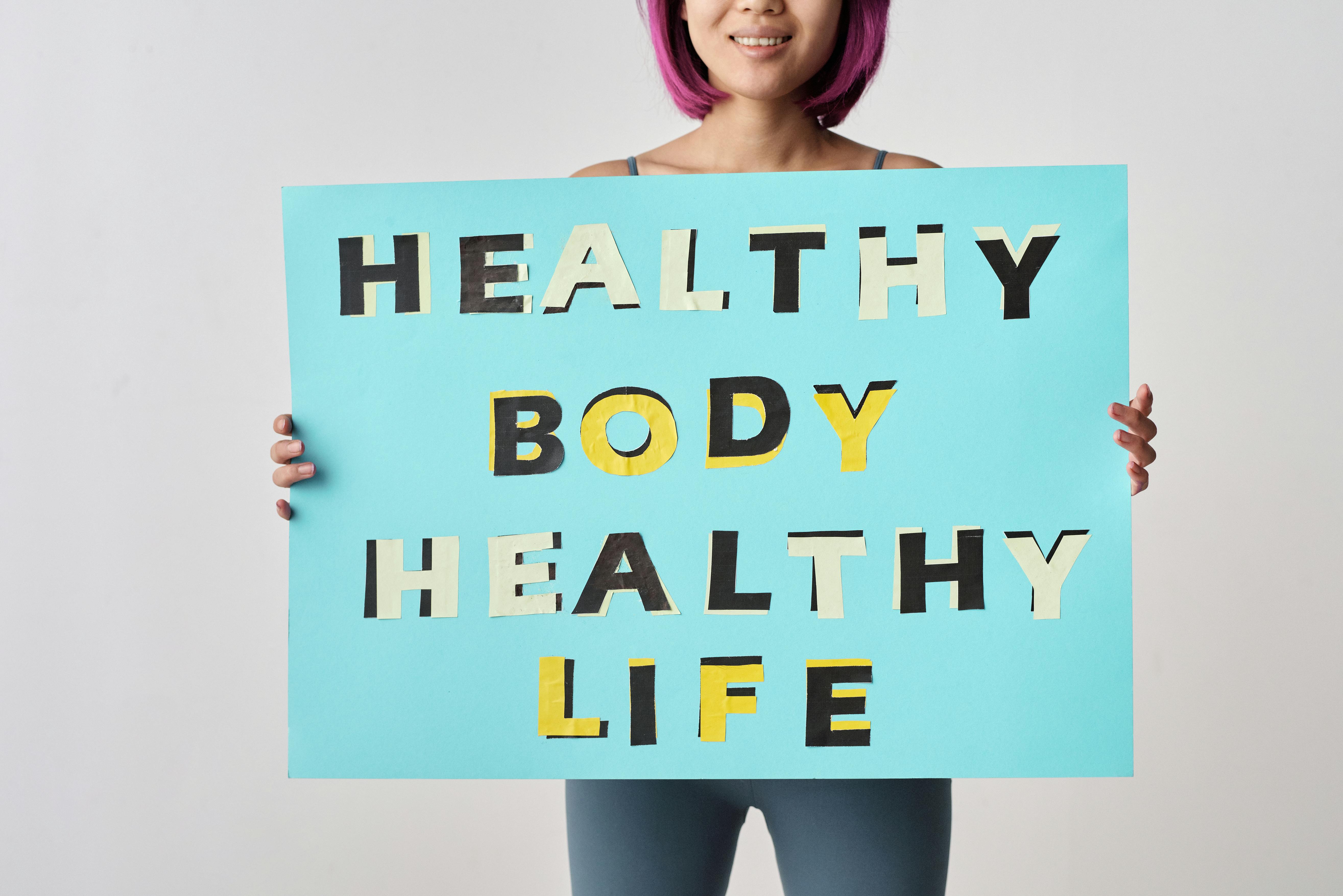 Person Holding a Blue Poster with Message