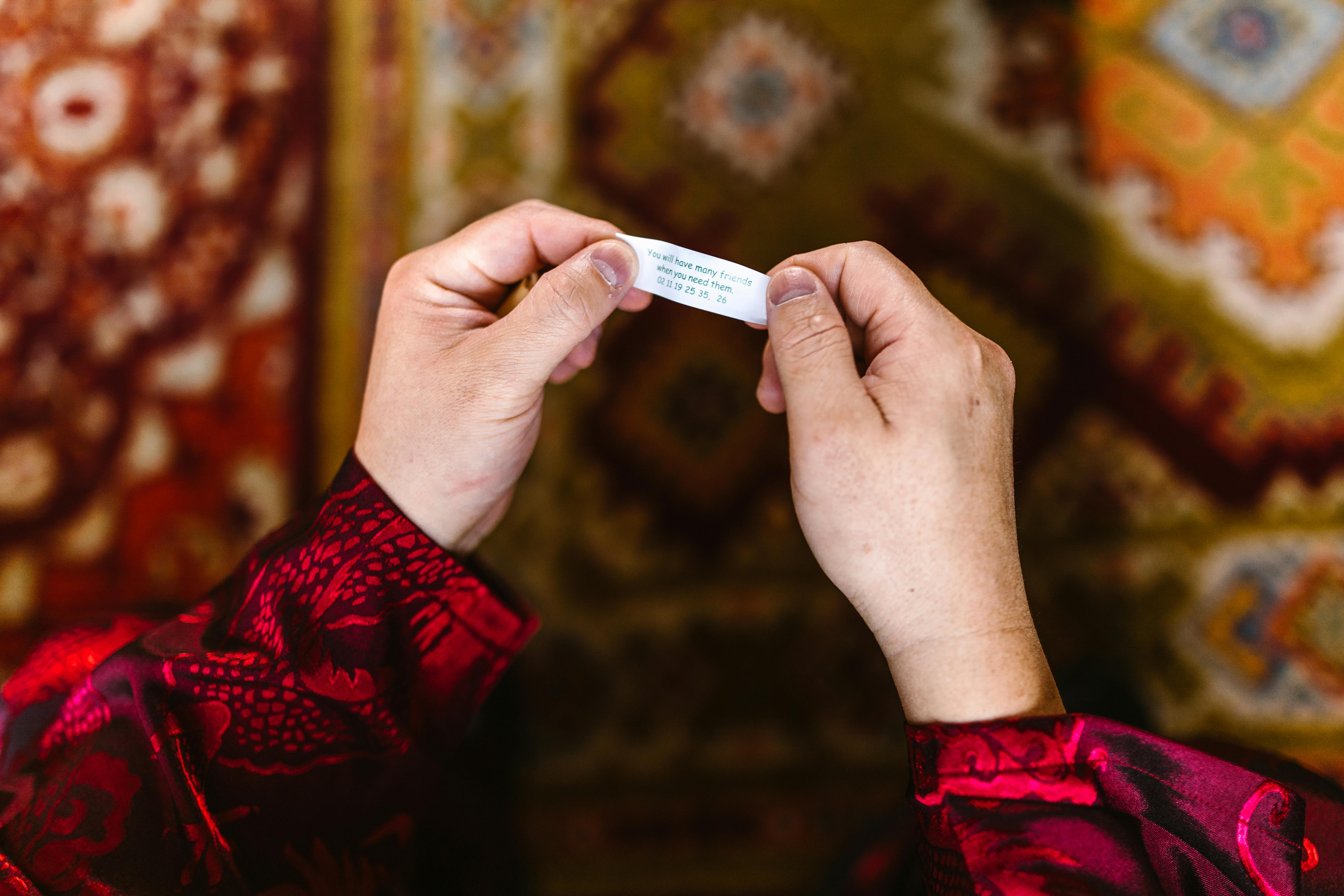 A Person Holding a Message on a Strip of Paper
