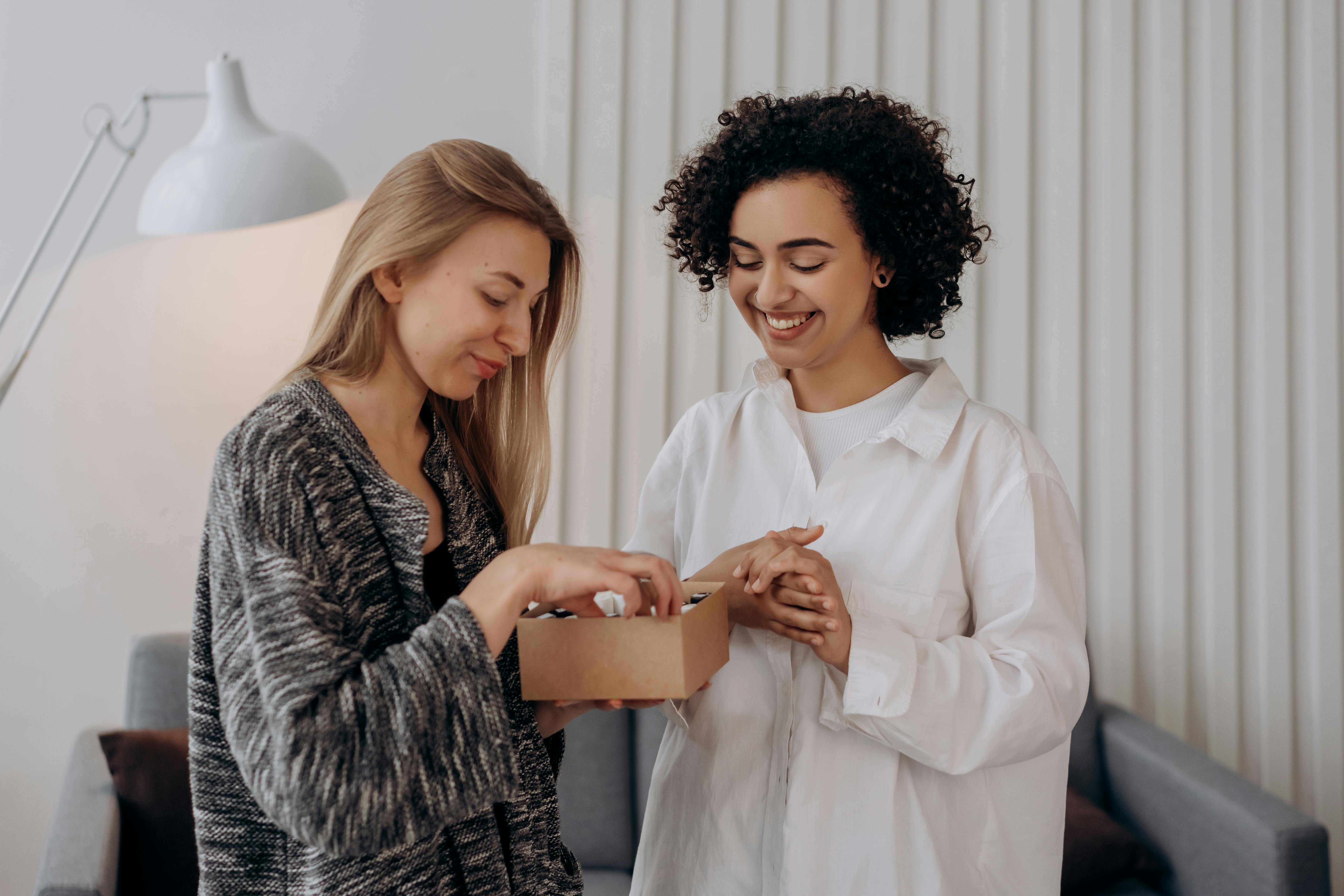 Two Women Checking On A Box Of Essential Oils