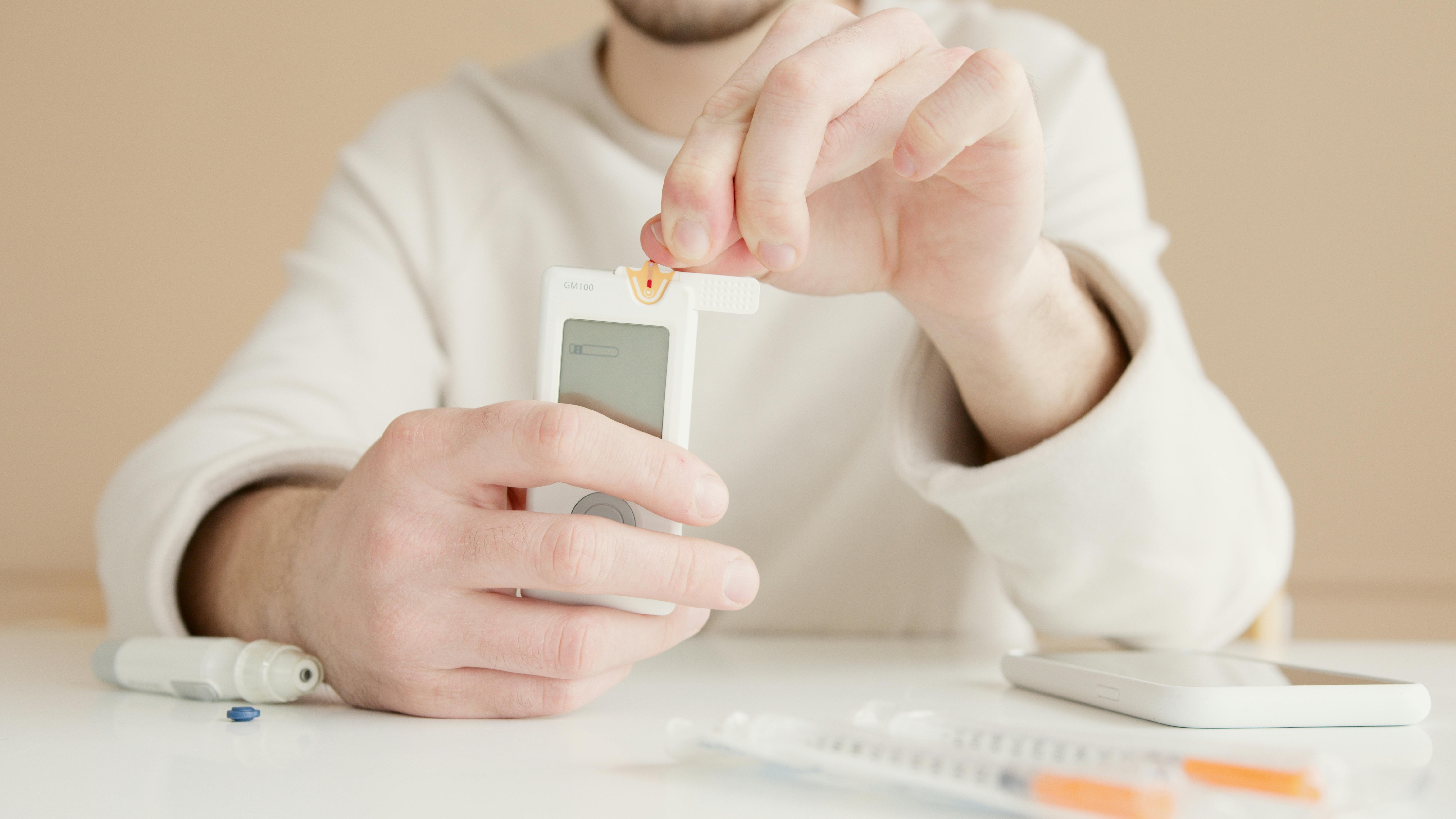 Person Using a Blood Glucose Meter