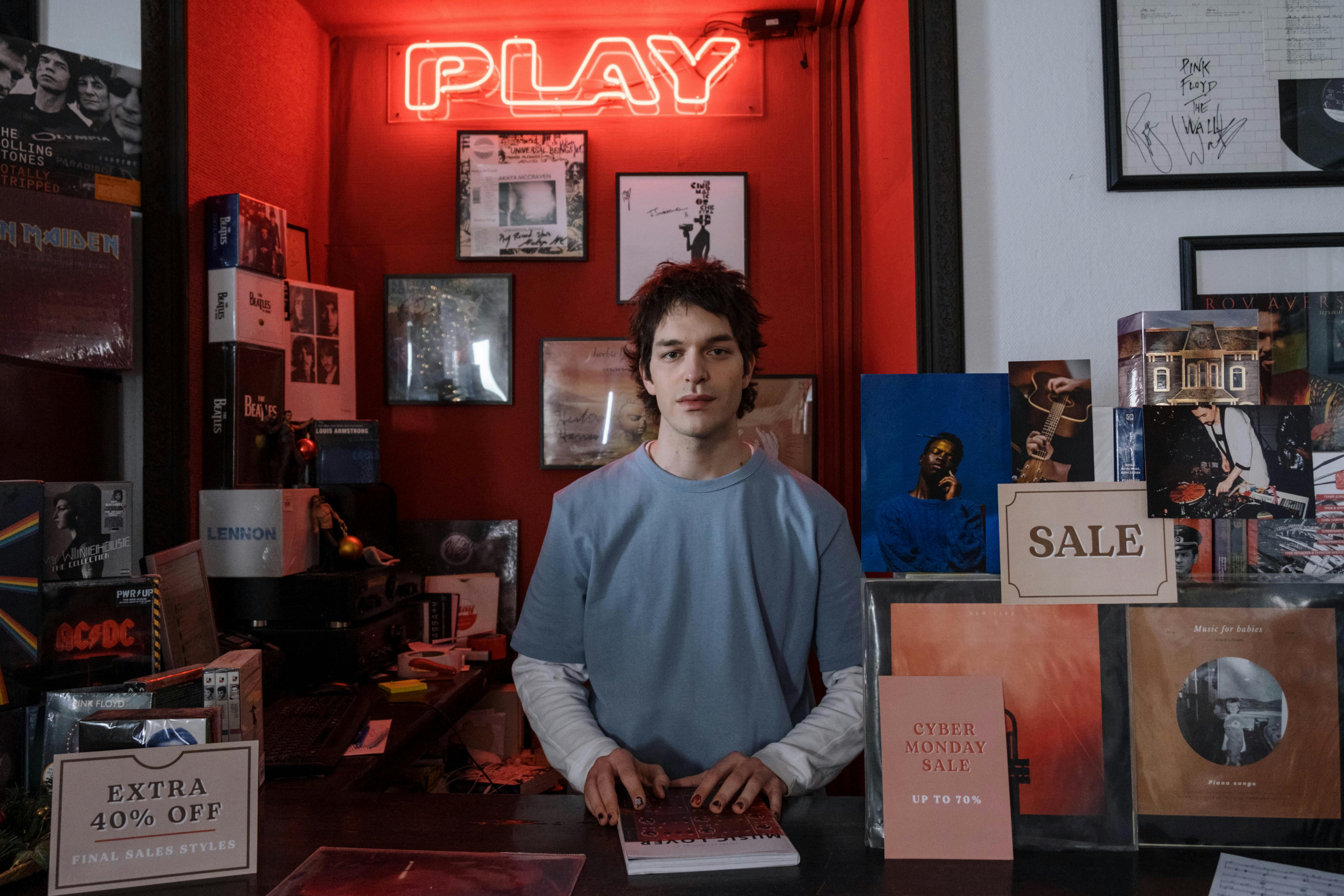 A Man Behind the Counter of a Record Store