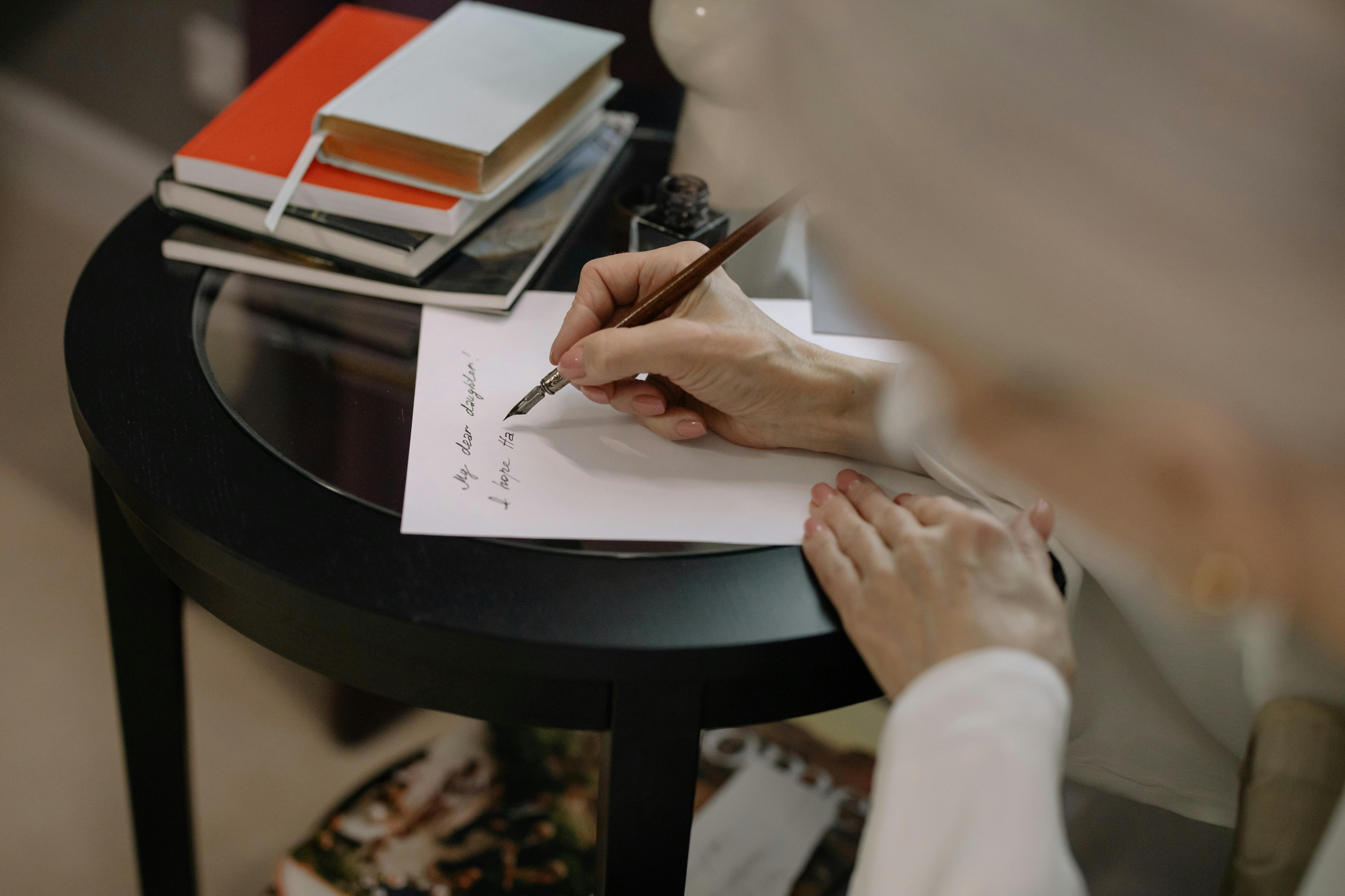 Person Writing on White Paper