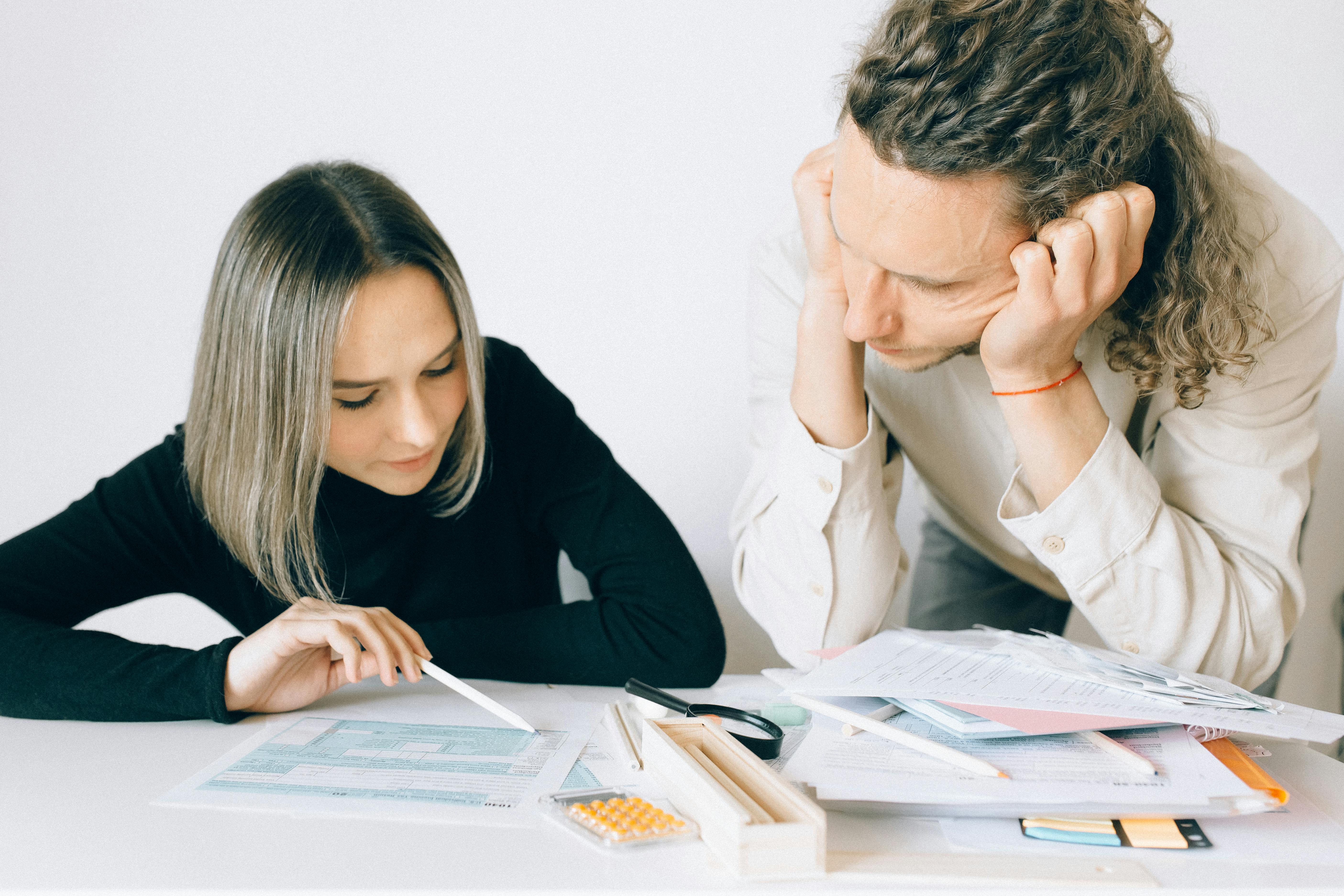 Man and Woman Looking at the Document