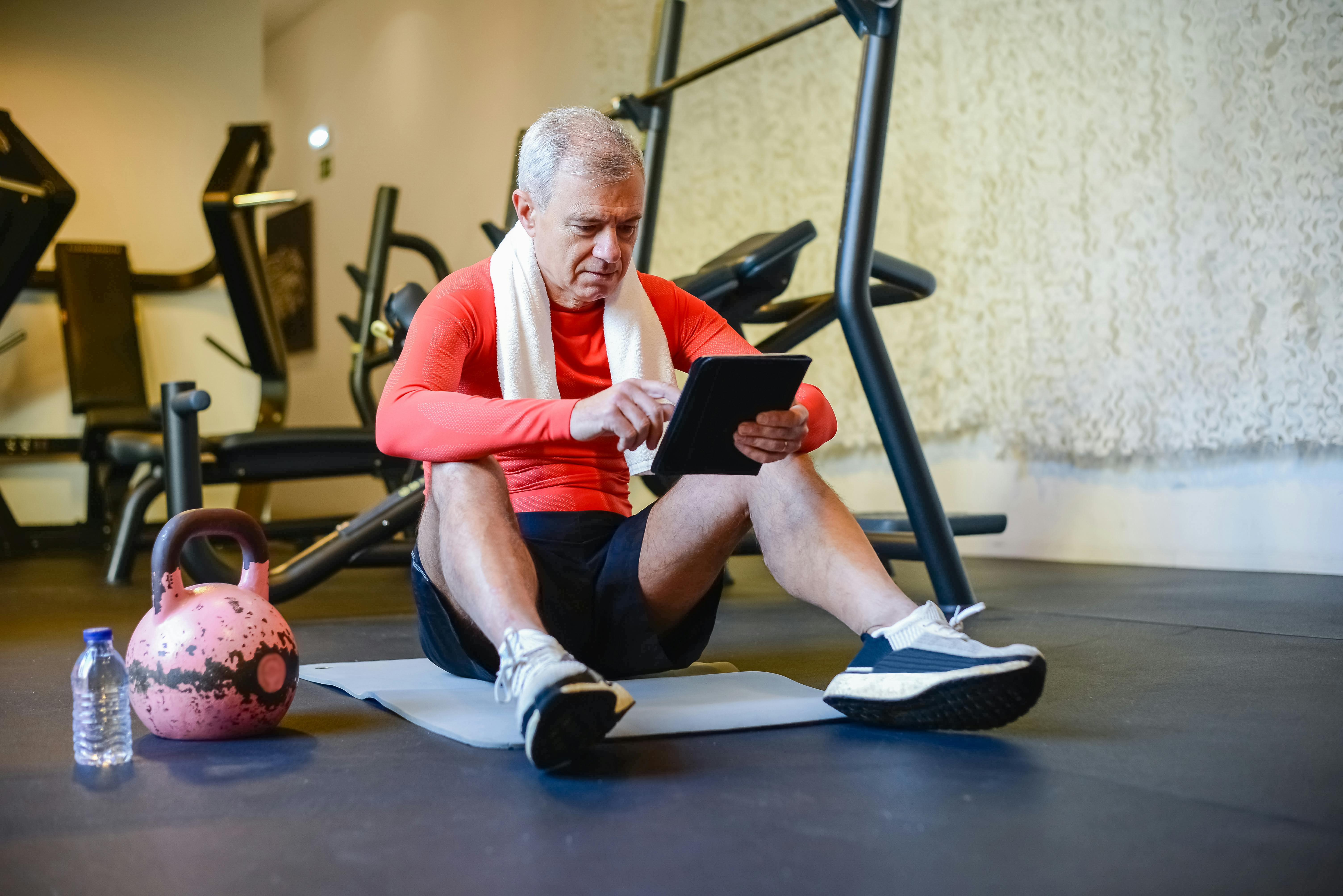 Man Using a Tablet at the Gym