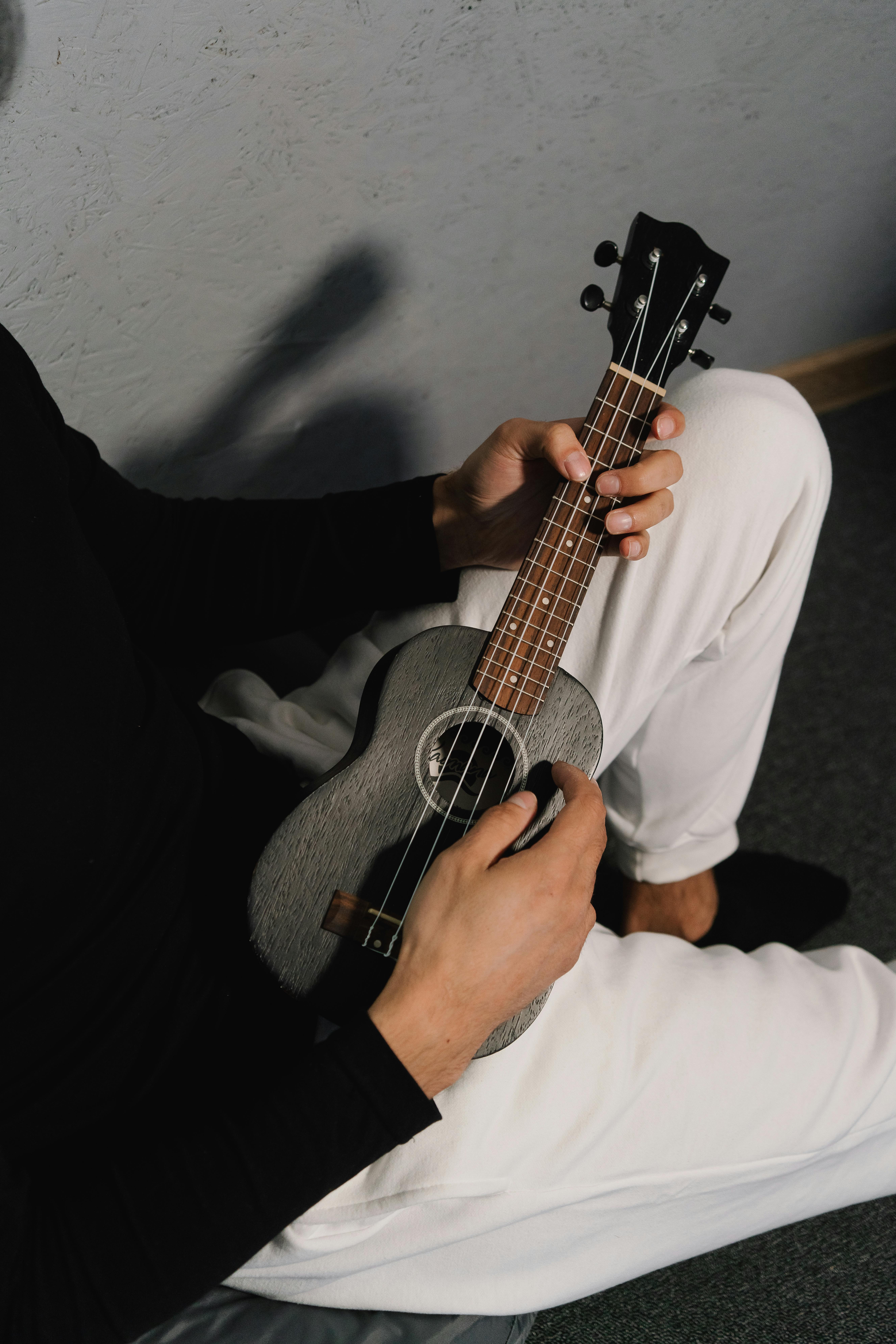 Man in White Shirt Playing Acoustic Guitar
