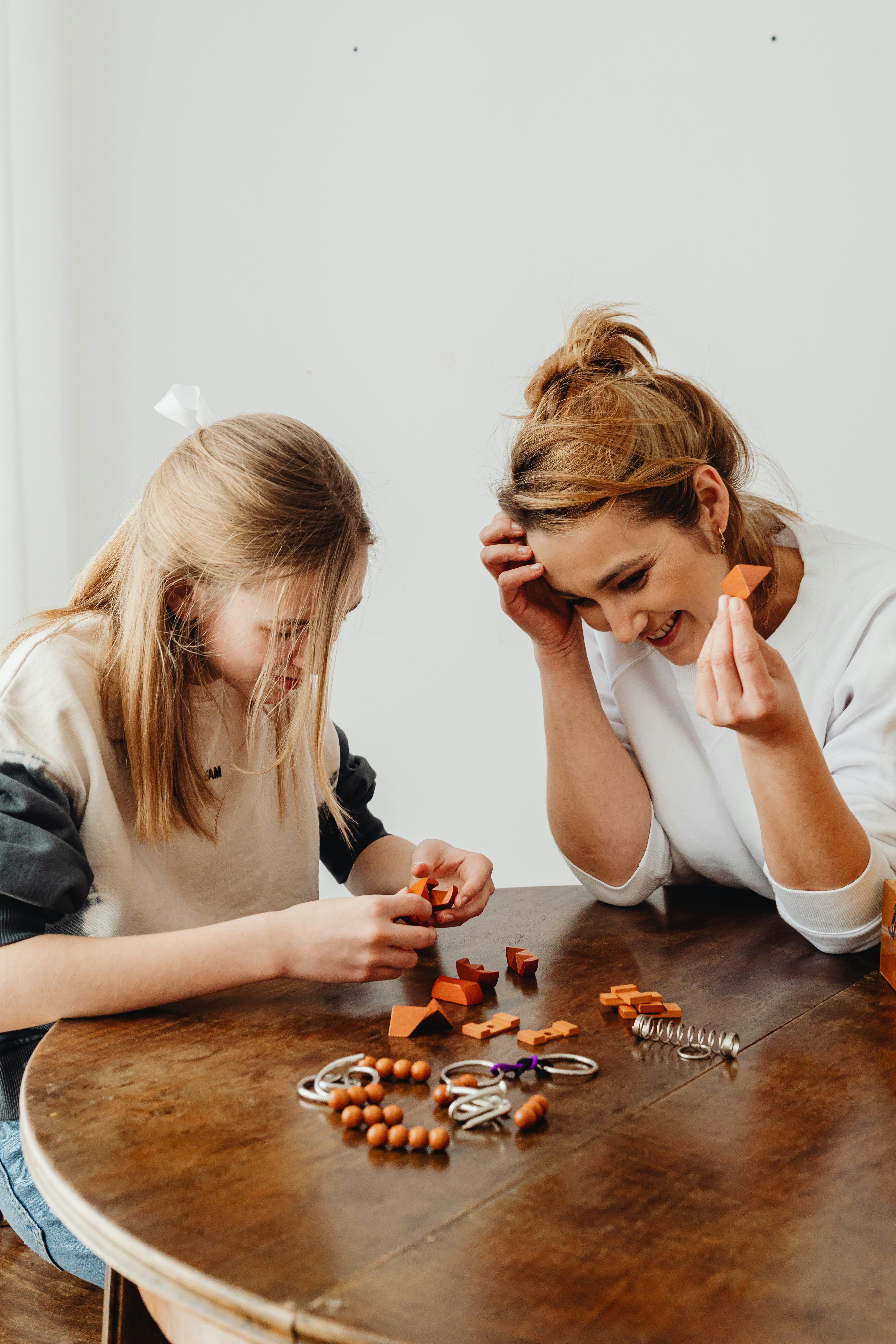 Smiling Women Sitting with Tools on Table