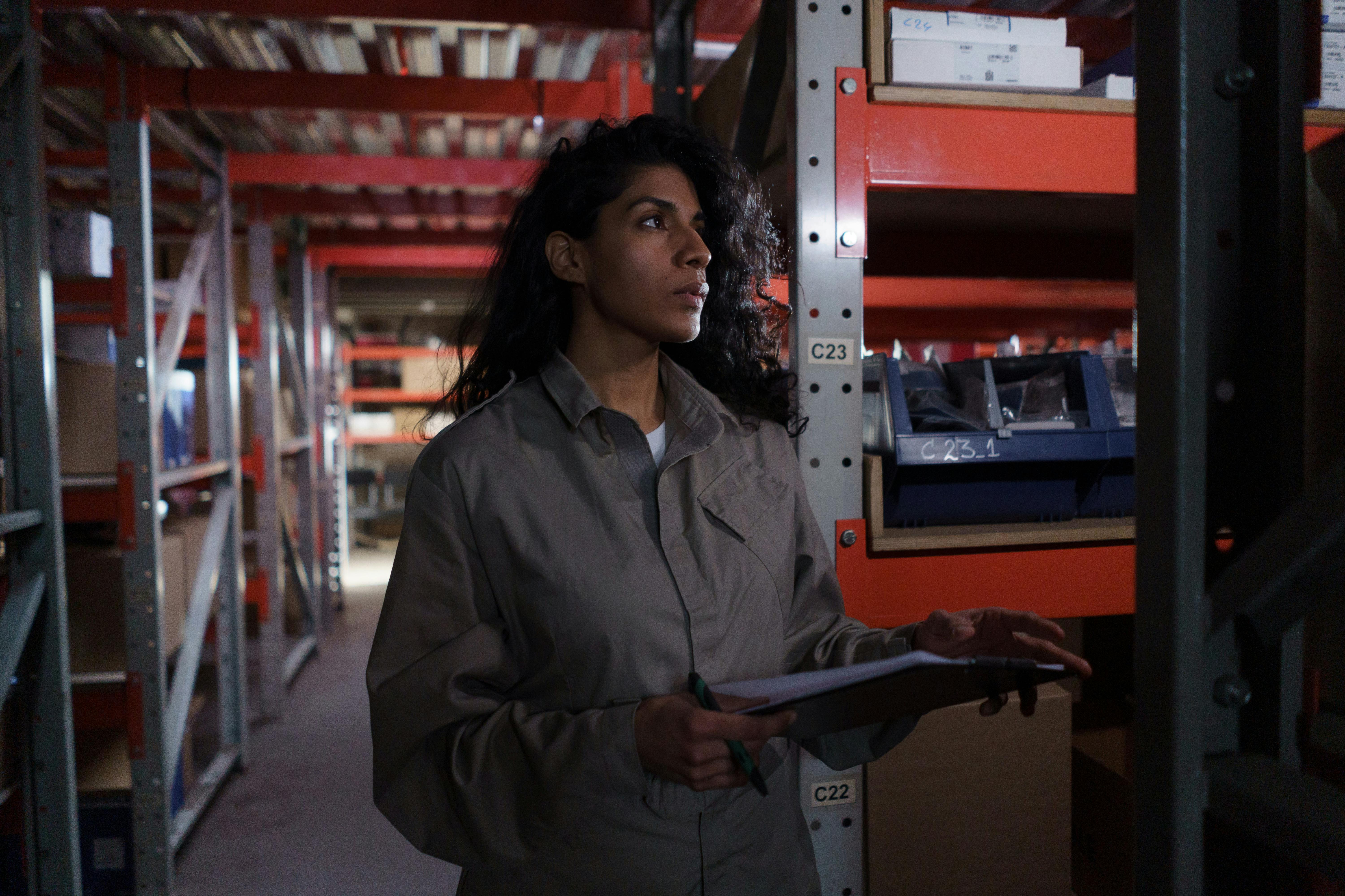 Woman Wearing Grey Uniform in Warehouse