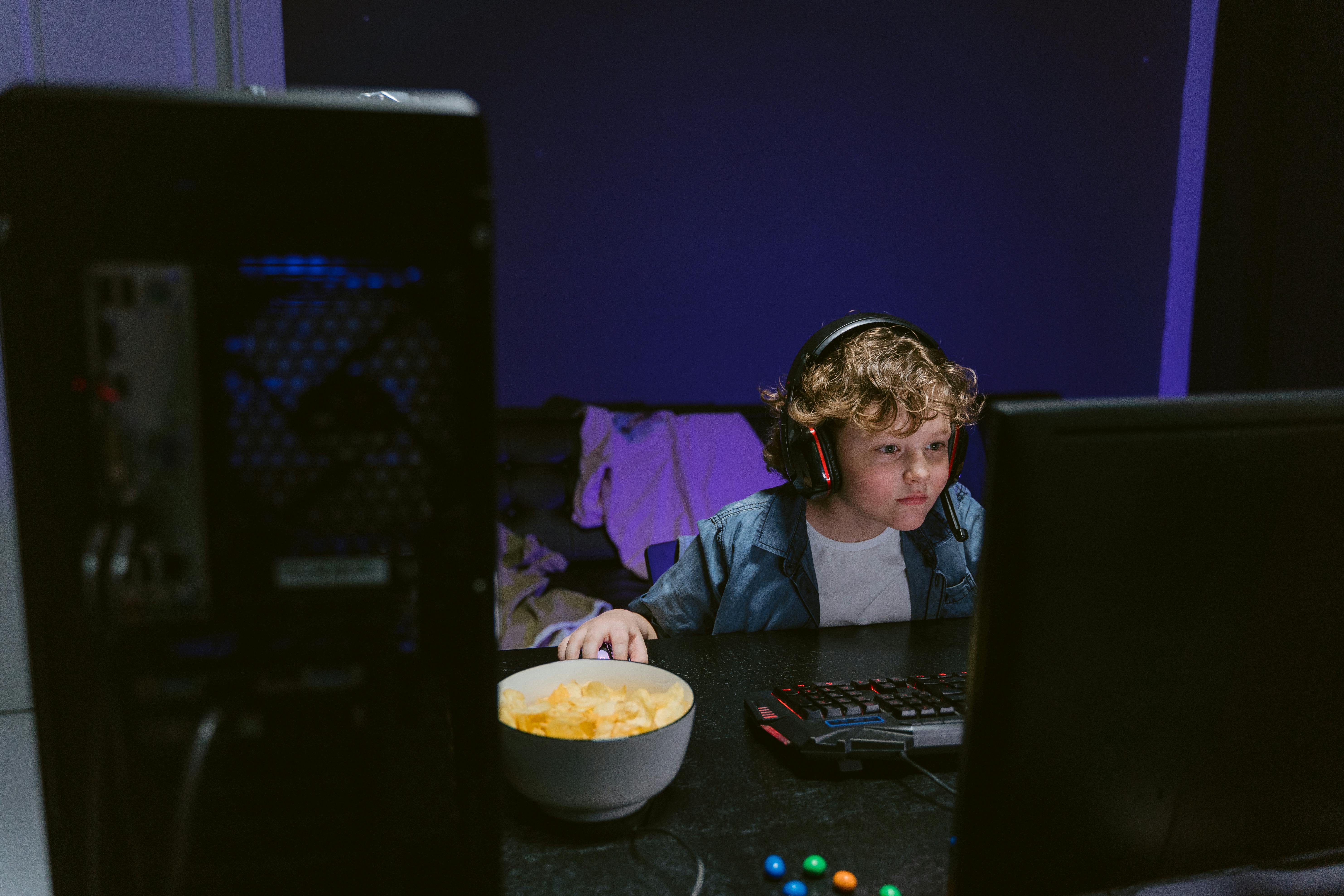 A Boy with Headset Using a Computer