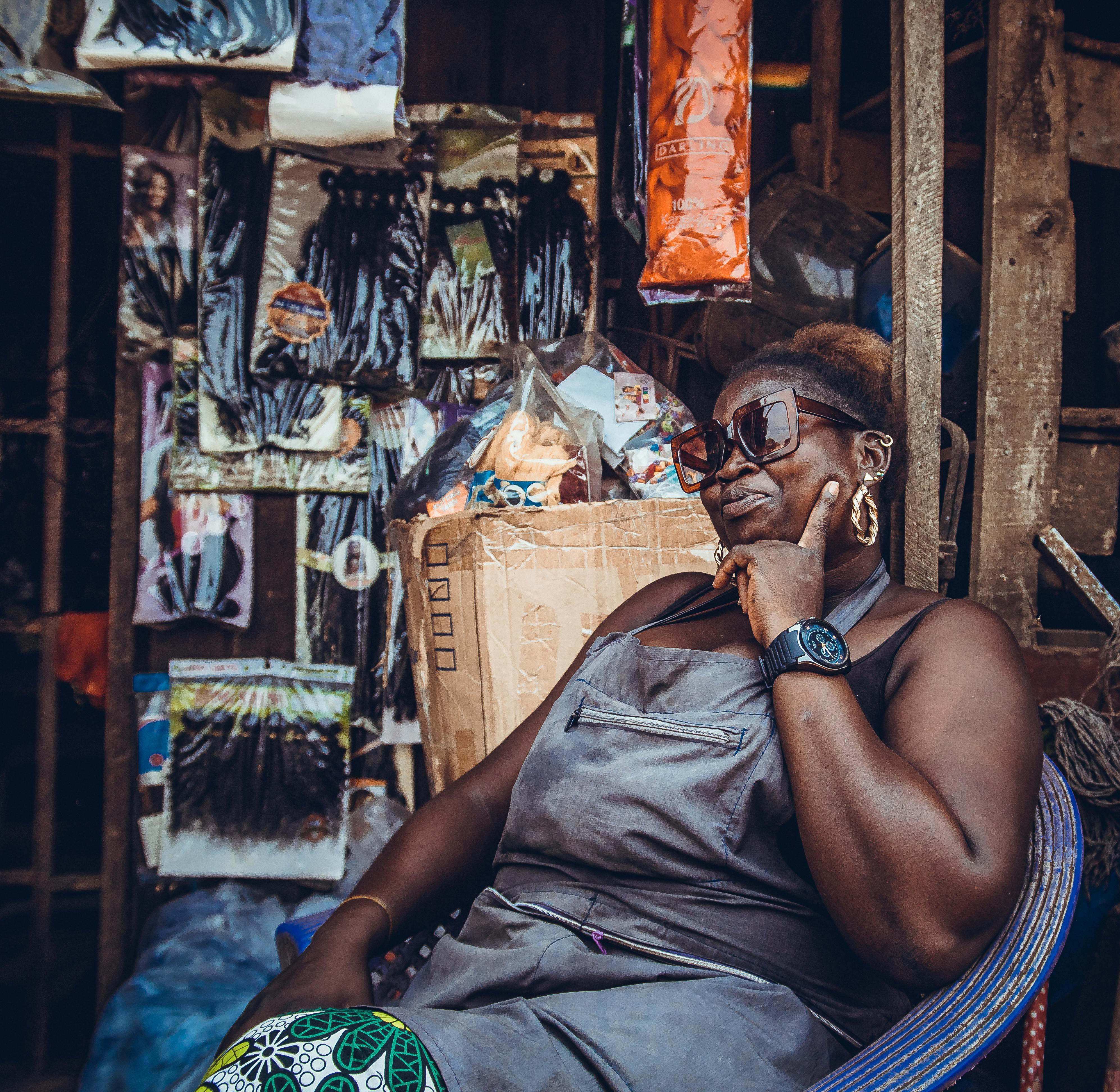 A Woman Wearing Sunglasses Pointing at her Cheek