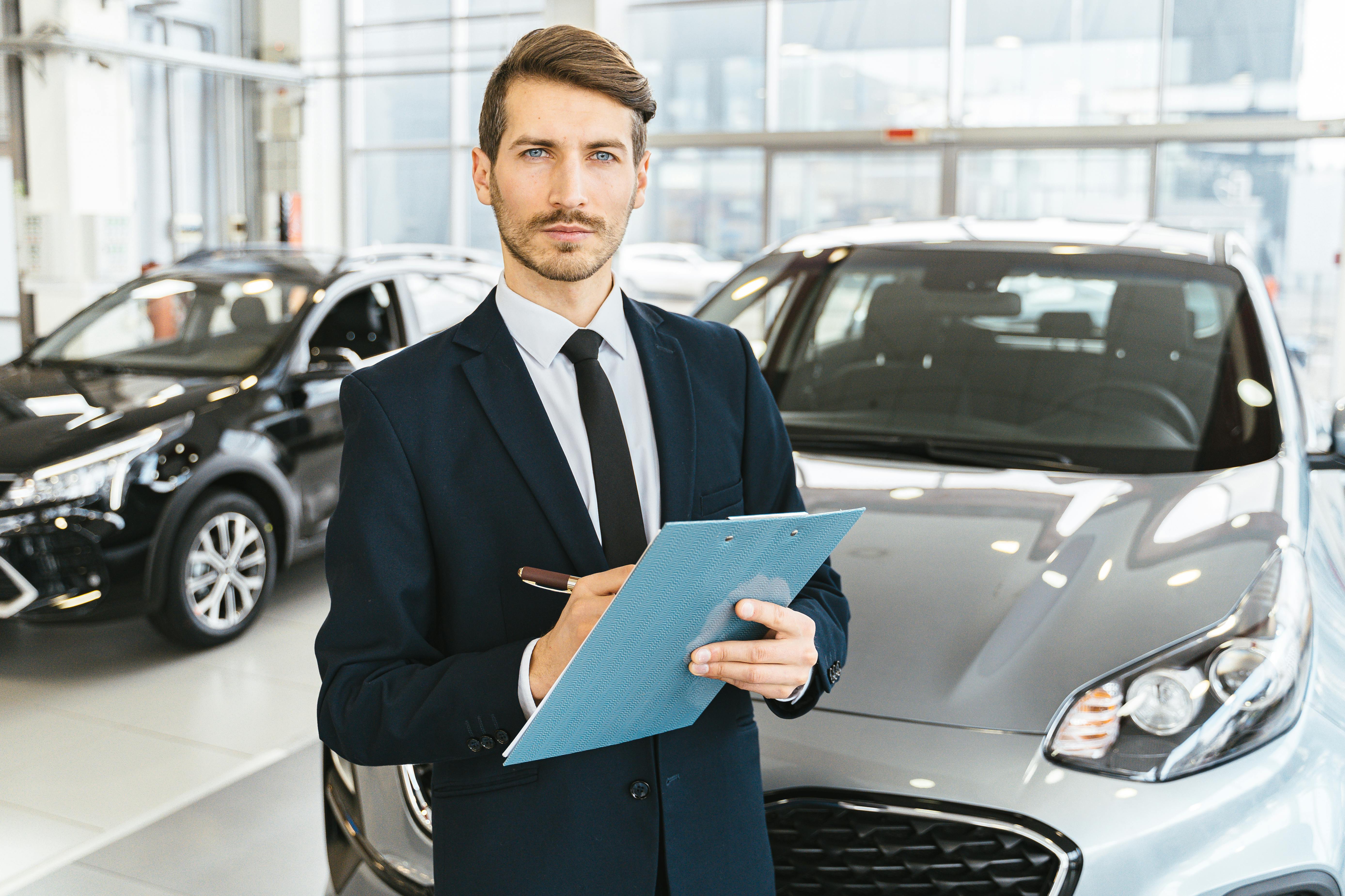 Man in Blue Business Attire Holding Blue Folder