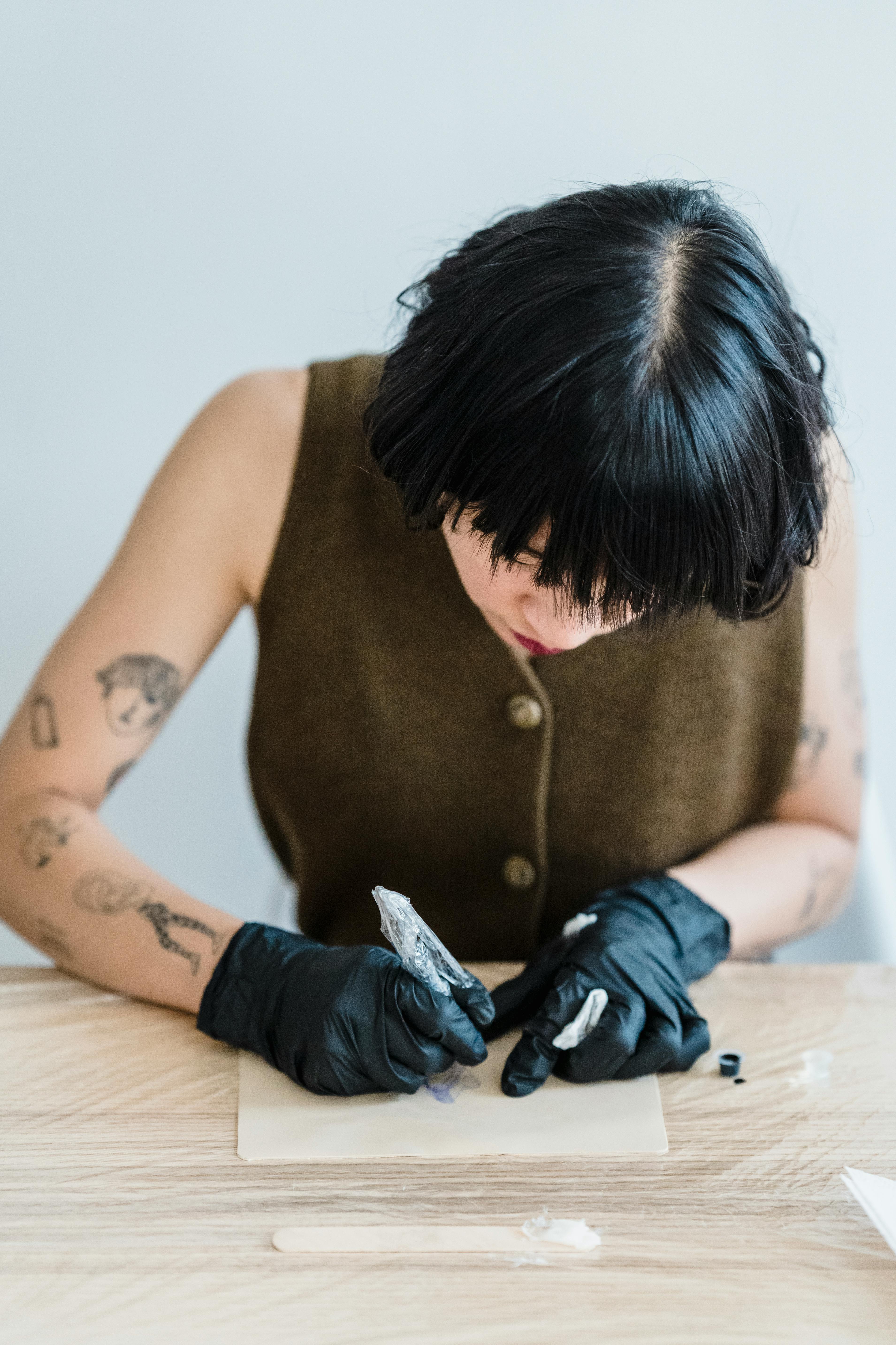 Close-up Photo of Focused Woman writing on Paper 