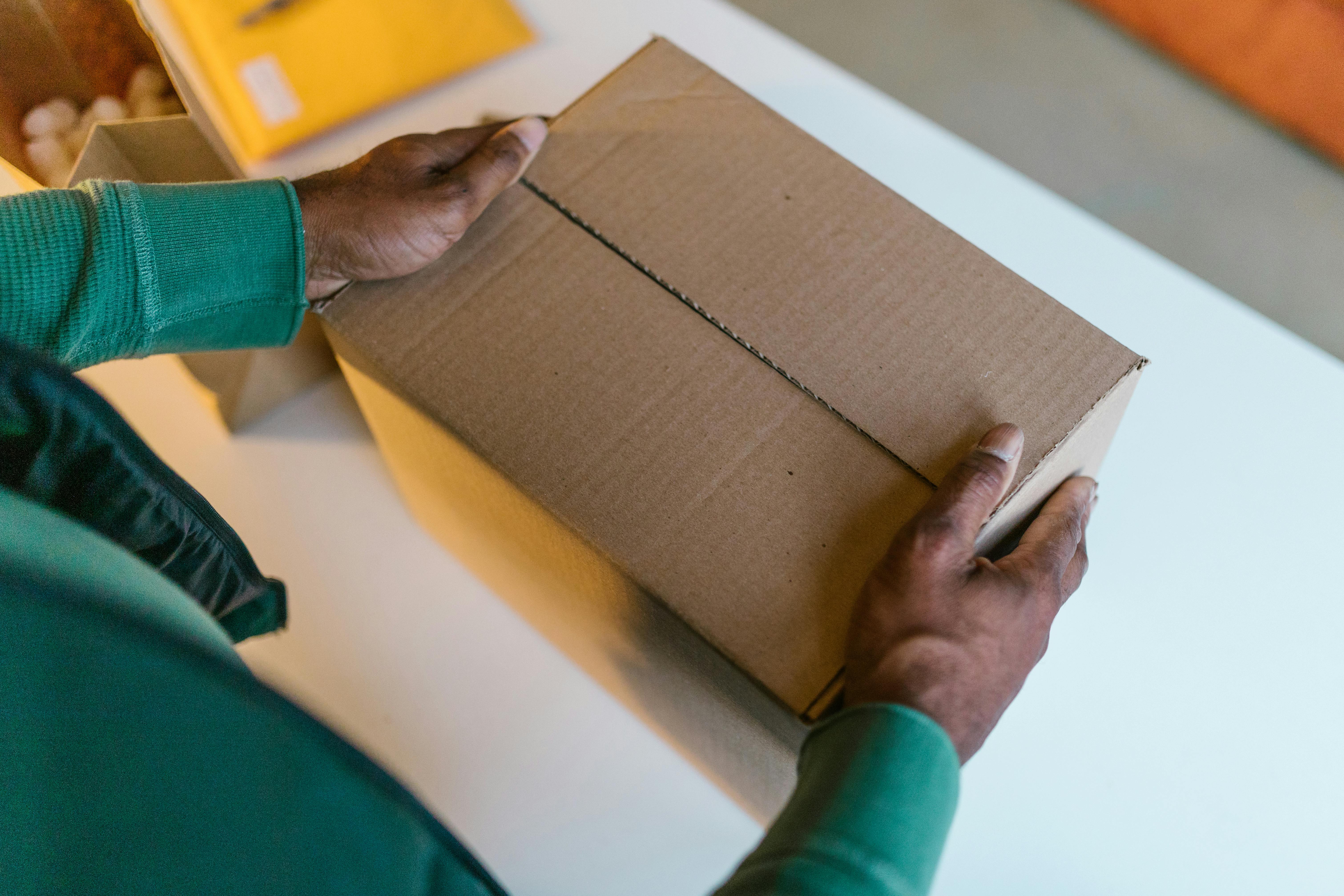 High-Angle Shot of a Man Holding a Box