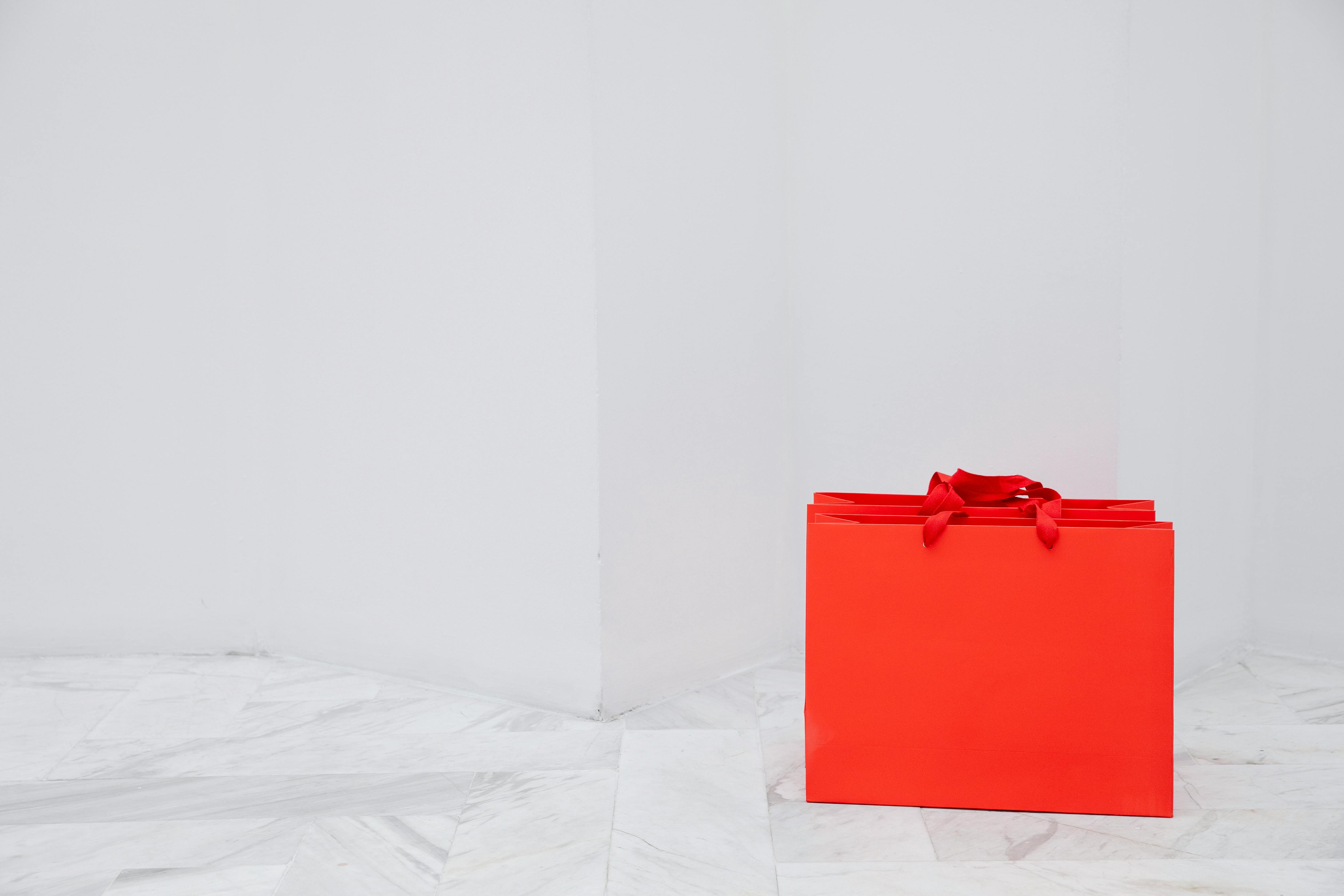 Orange Shopping Bags in a White Room