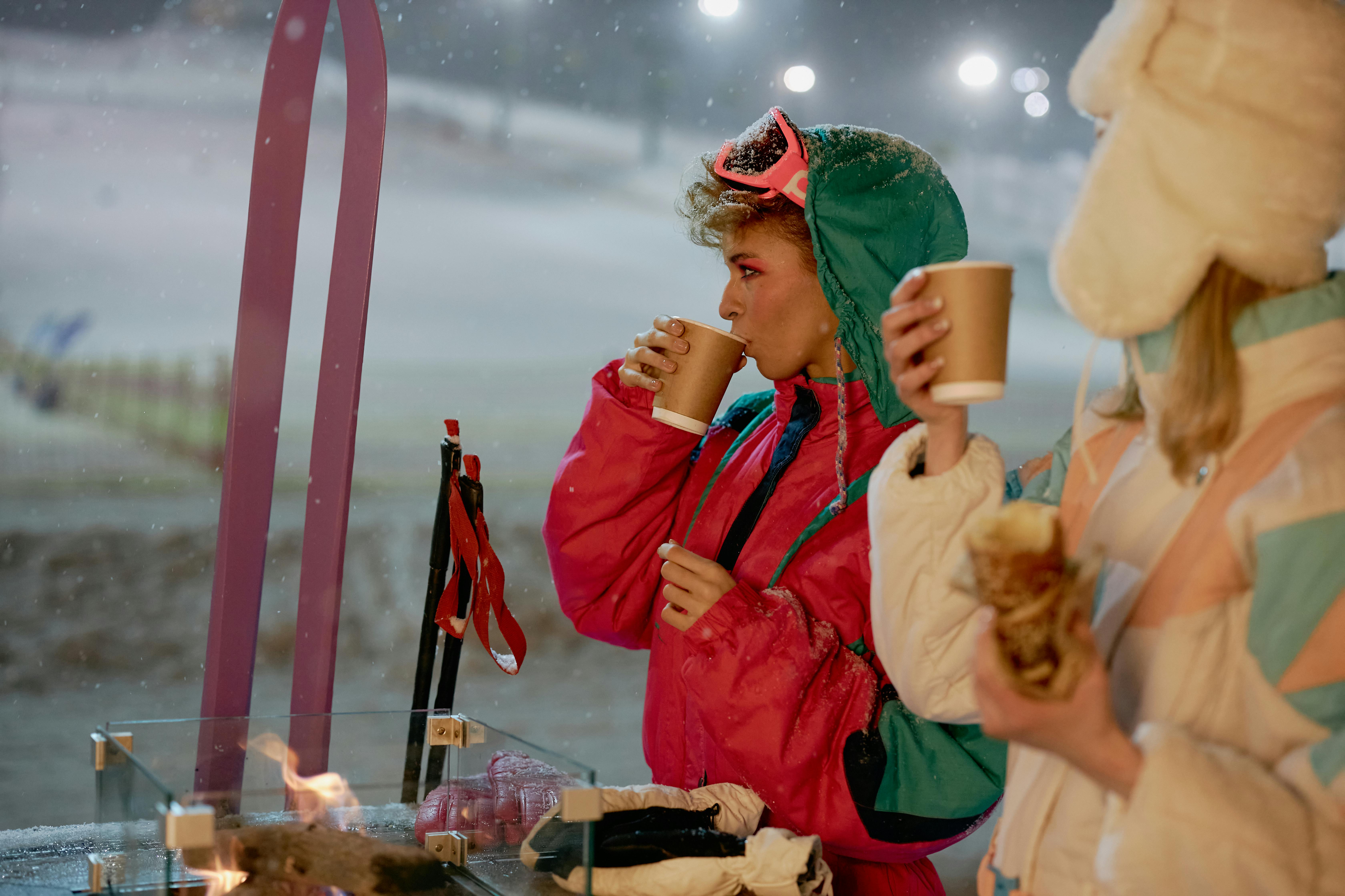Women at Ski Slope Drinking from Disposable Cups