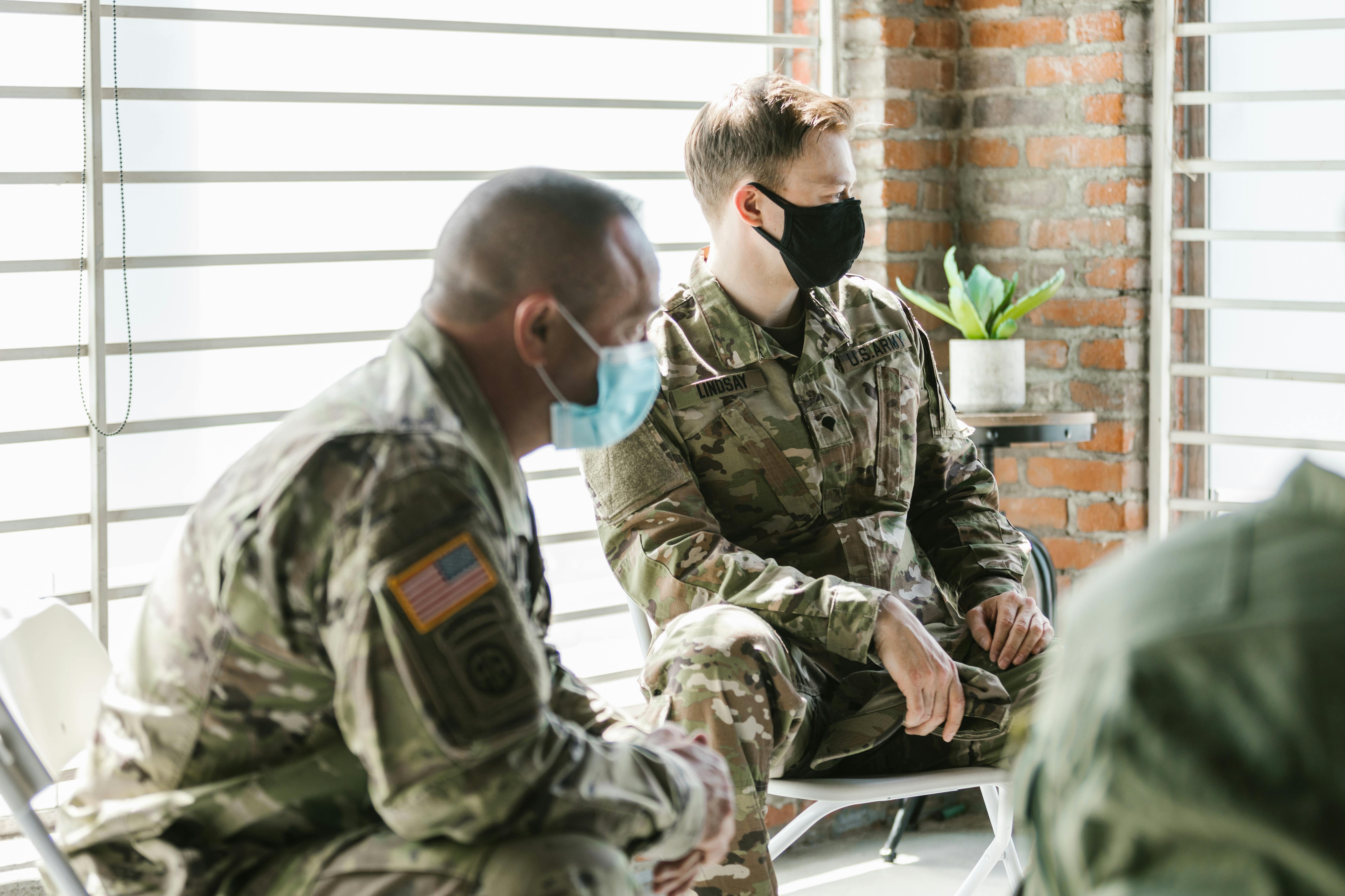 Photo of Soldiers Sitting Beside Each Other