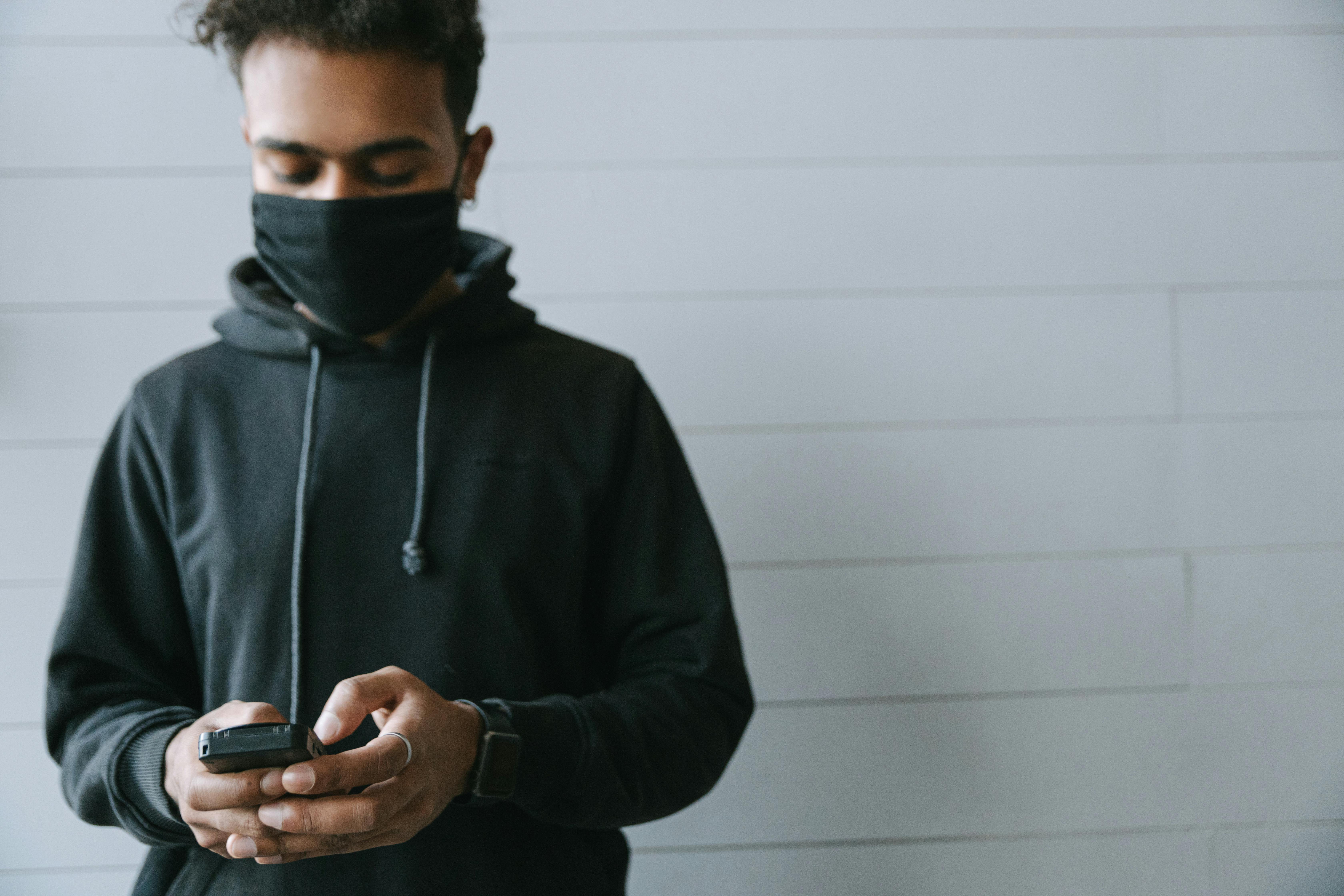 A Man Wearing a Black Hoodie using a Terminal