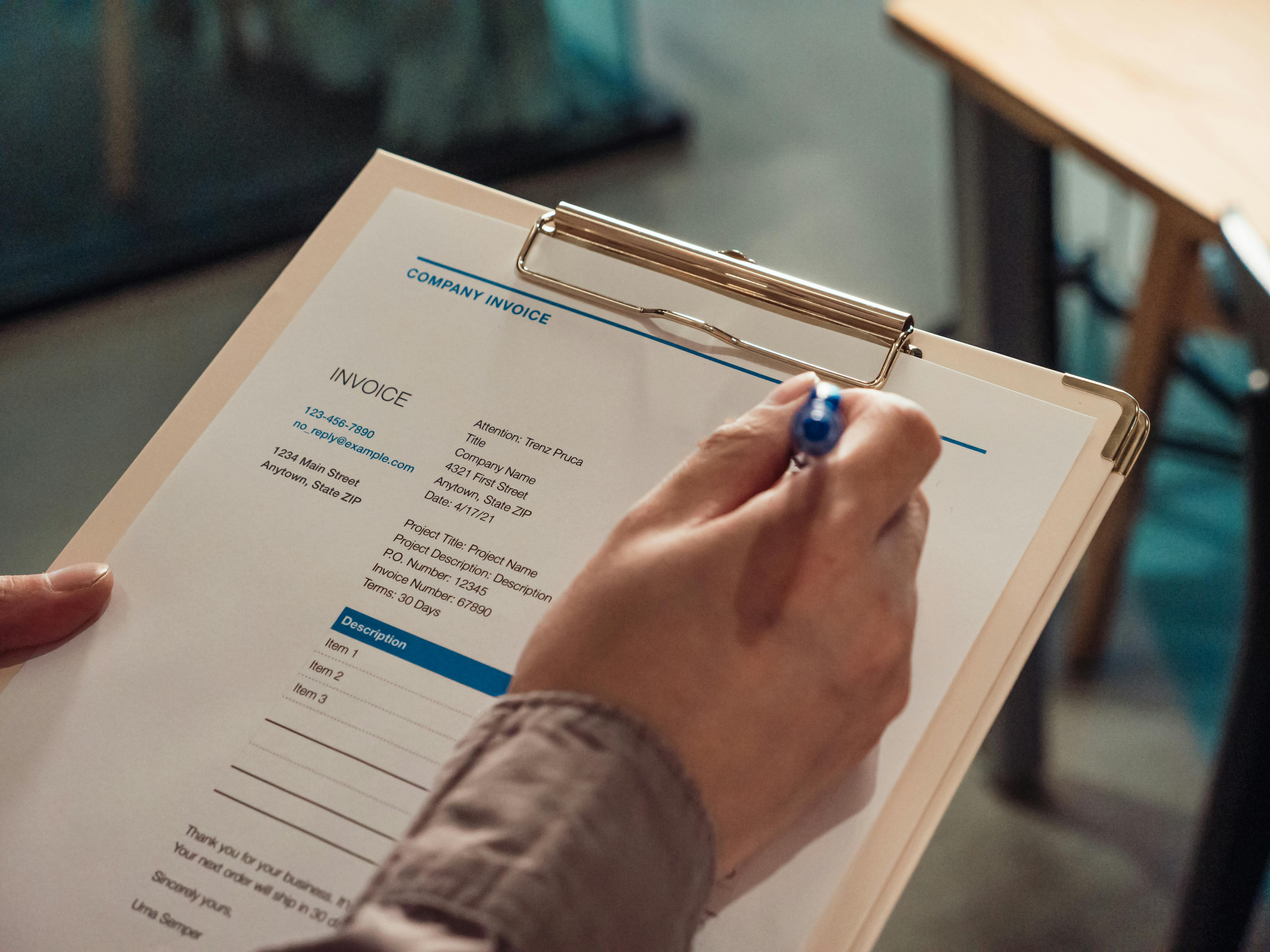 Close-Up Shot of a Person Holding a Clipboard