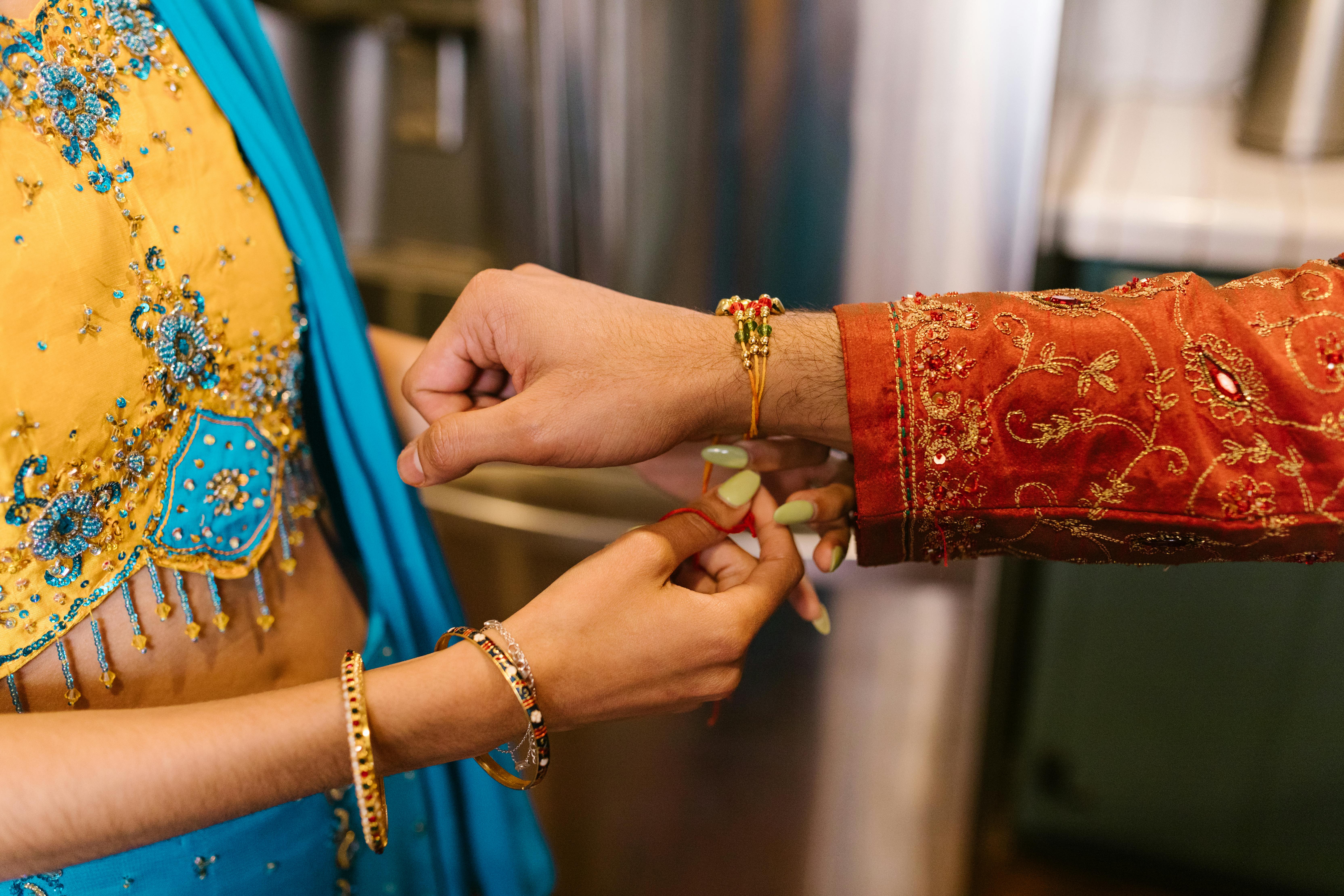 Woman Putting on a Bracelet on a Person's Hands