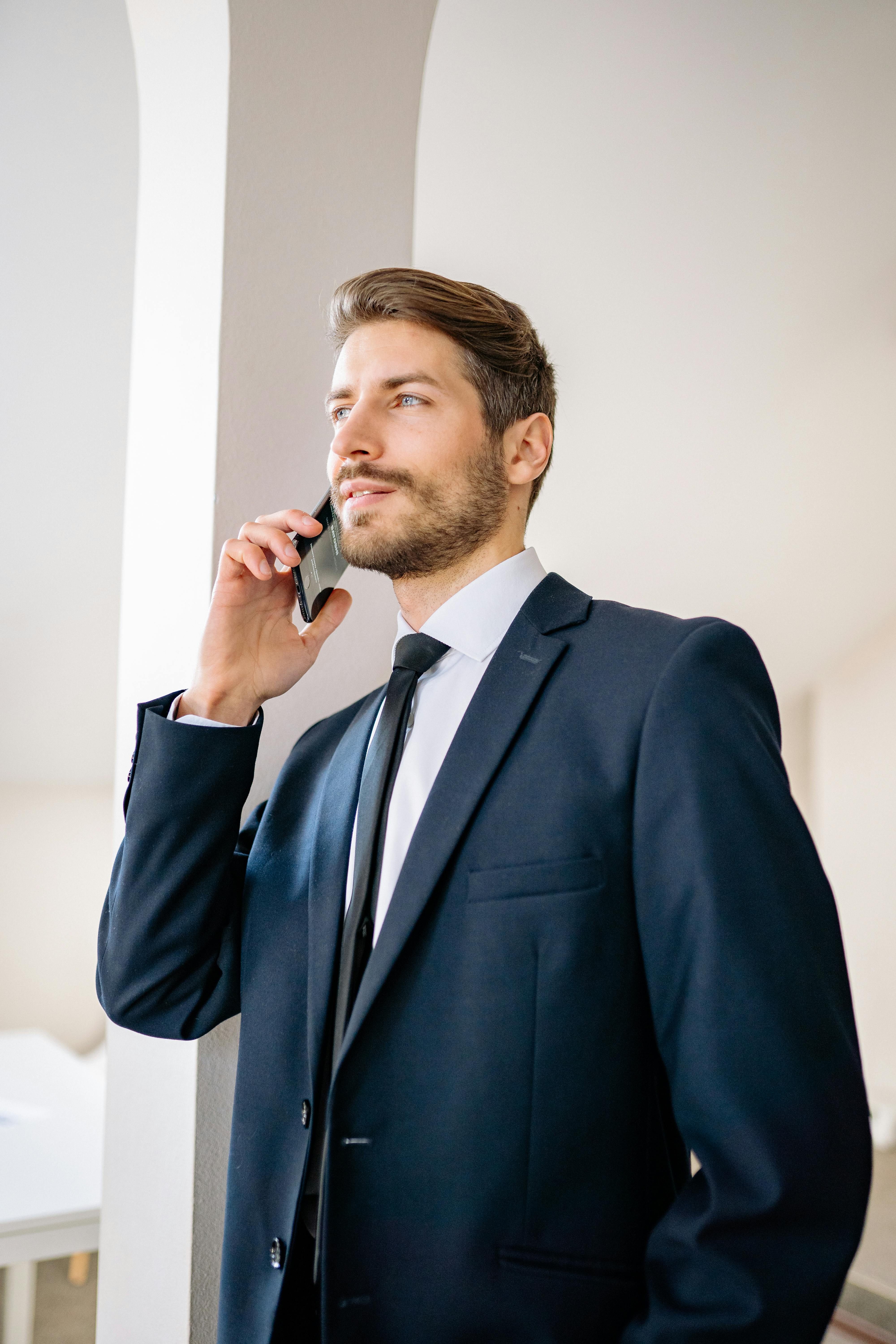 A Man in Blue Suit Talking on the Phone