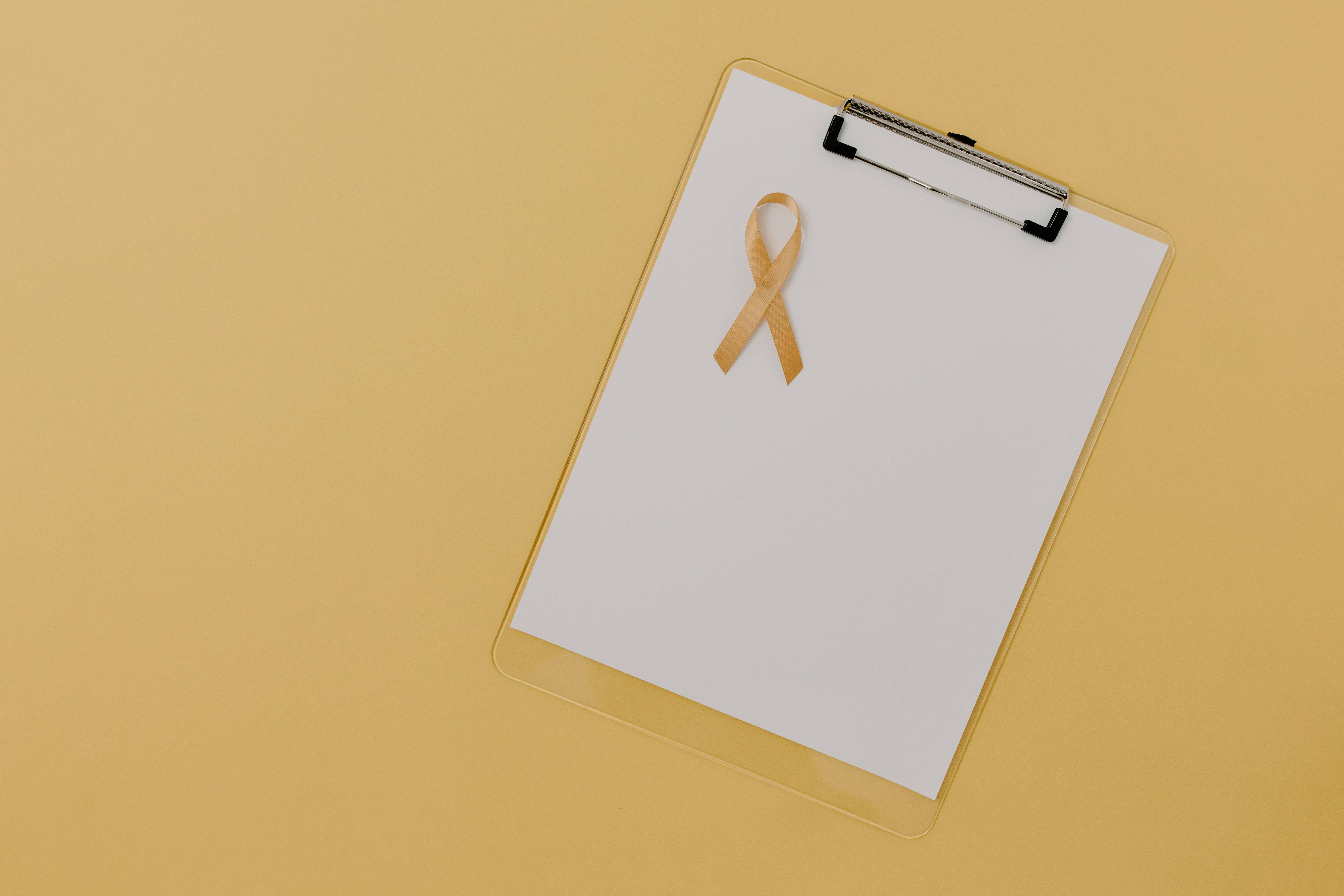 A Childhood Cancer Ribbon on White Paper