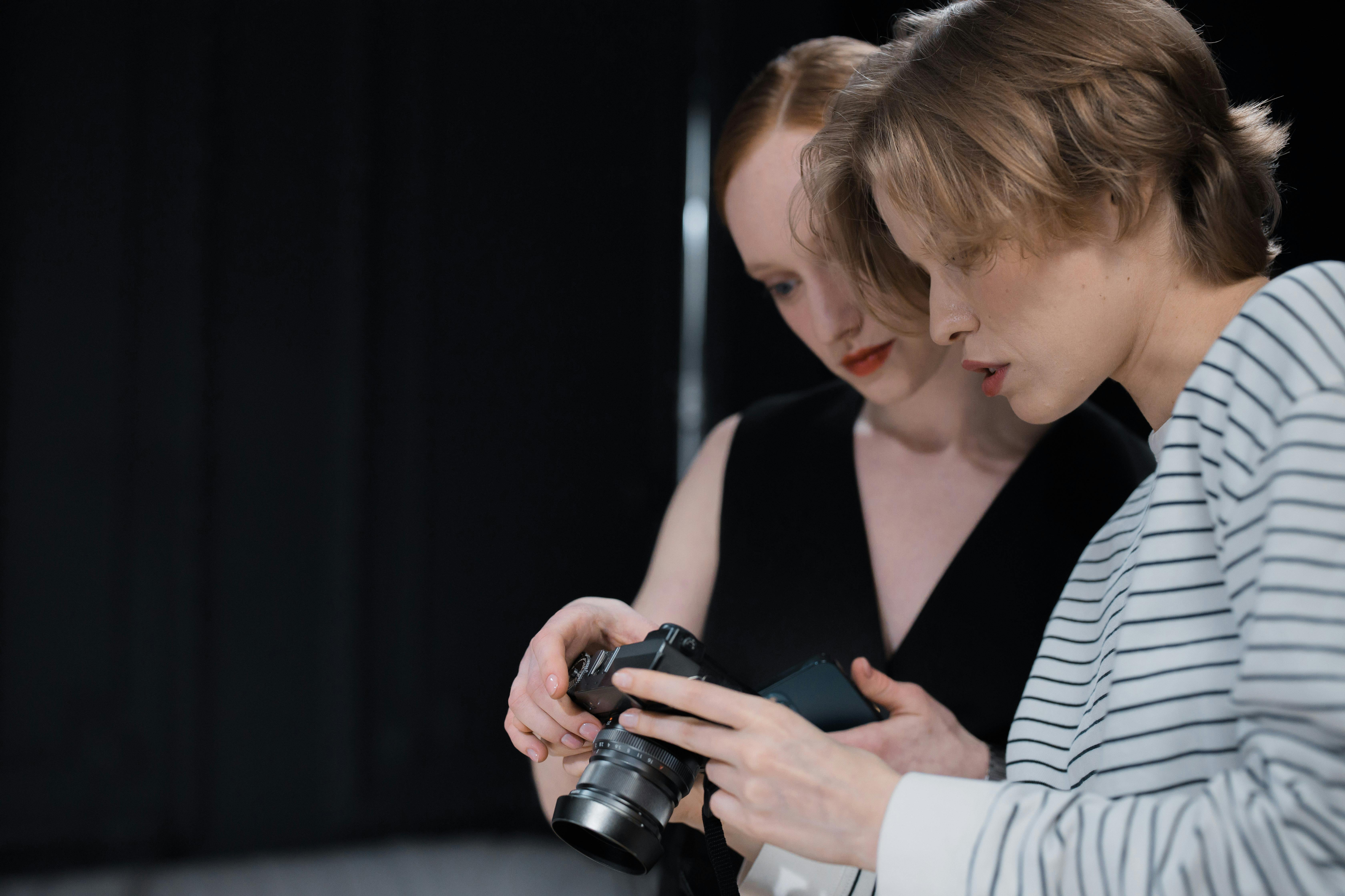 Shallow Focus of Two Women Holding a Camera