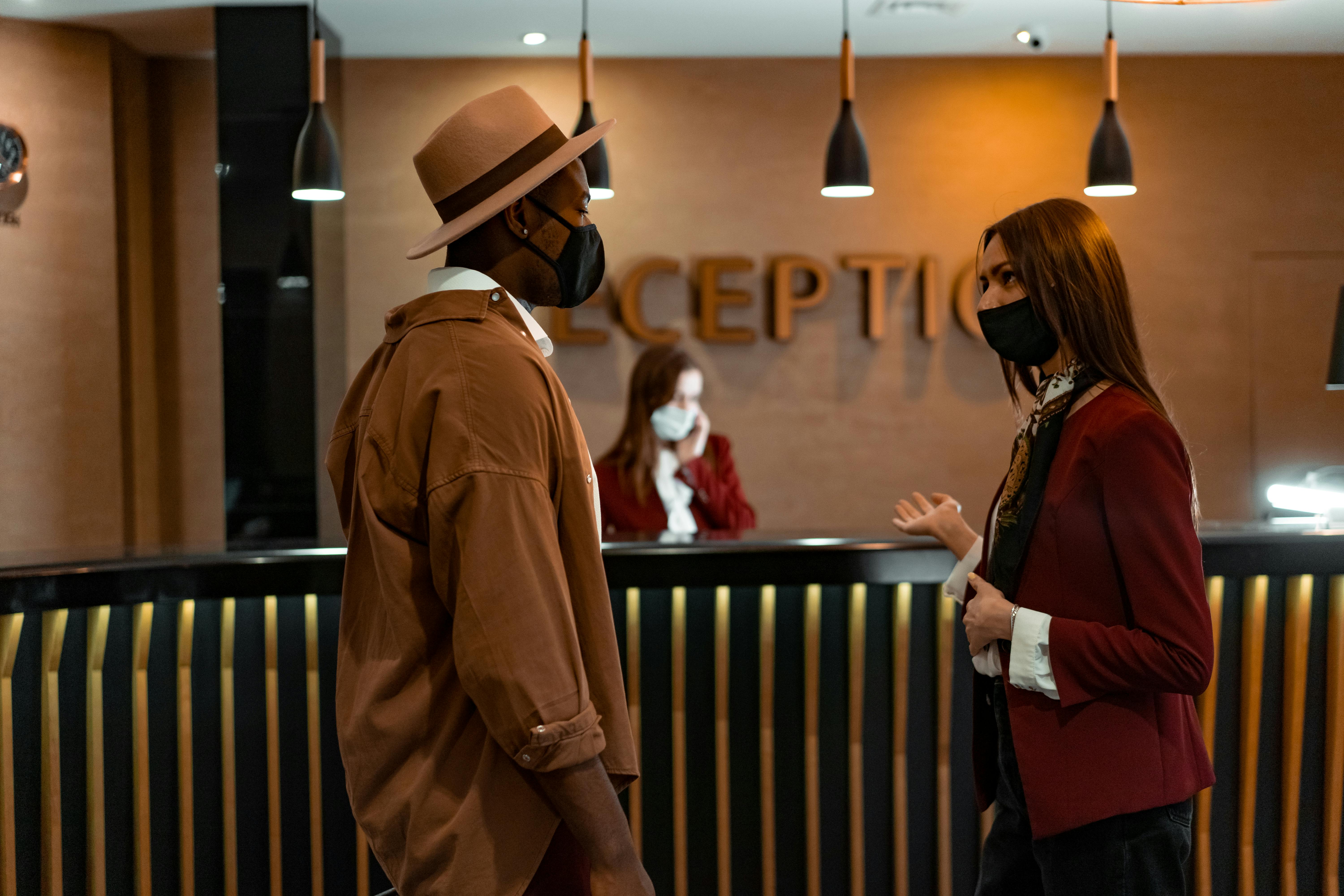 A Man and a Woman Talking at the Reception Area