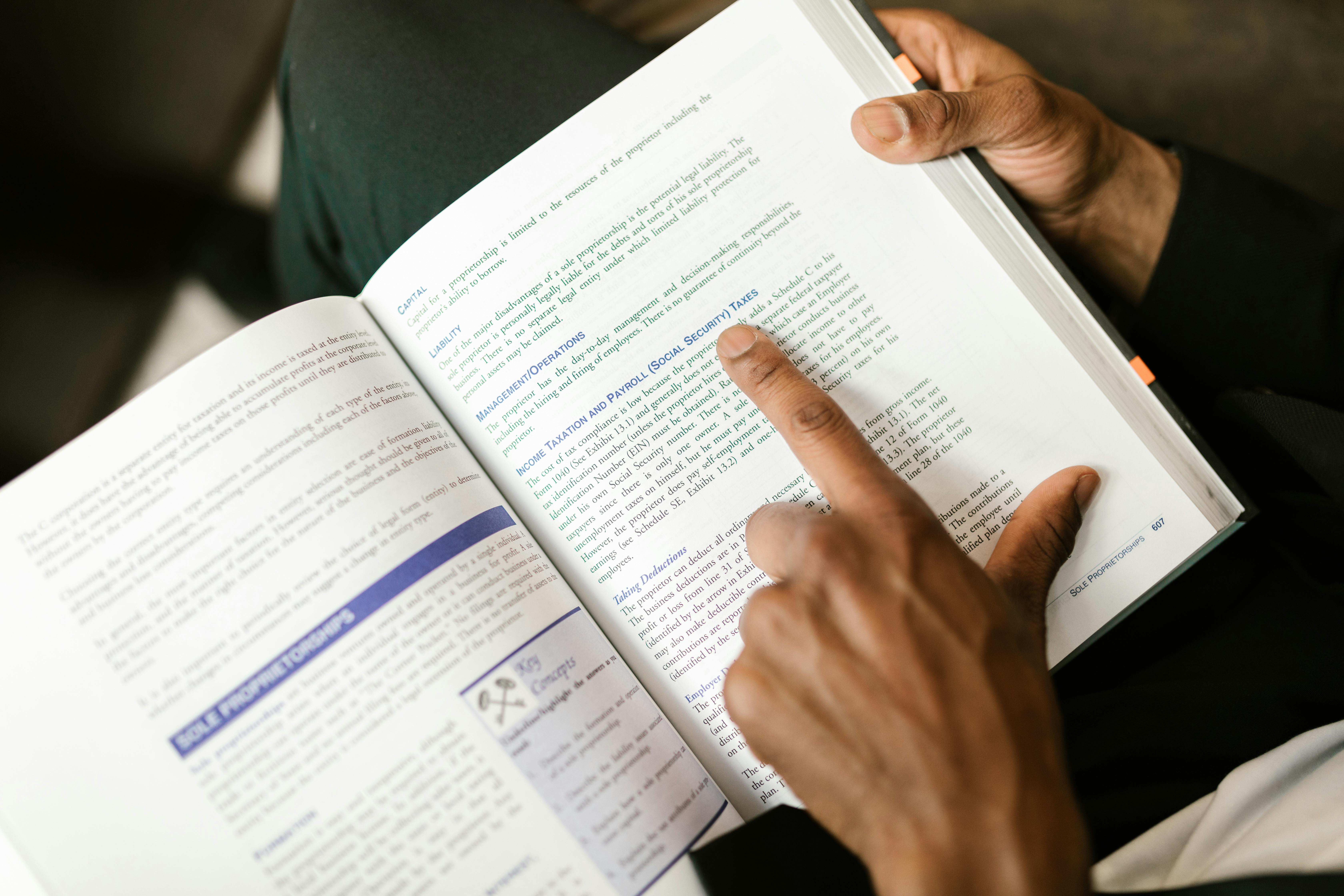 Person pointing on a Book