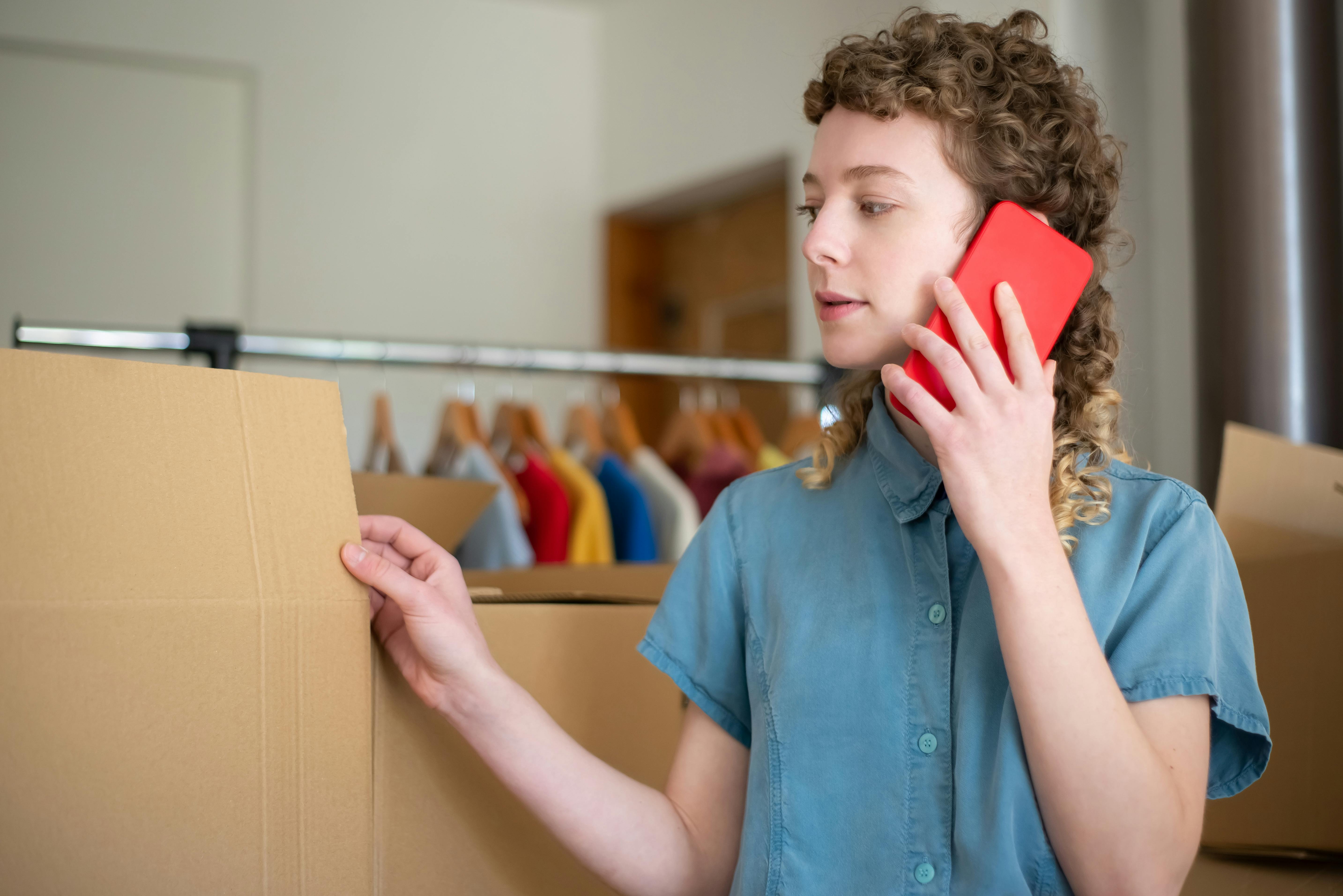 A Woman in Blue Button Up Shirt Talking on the Phone