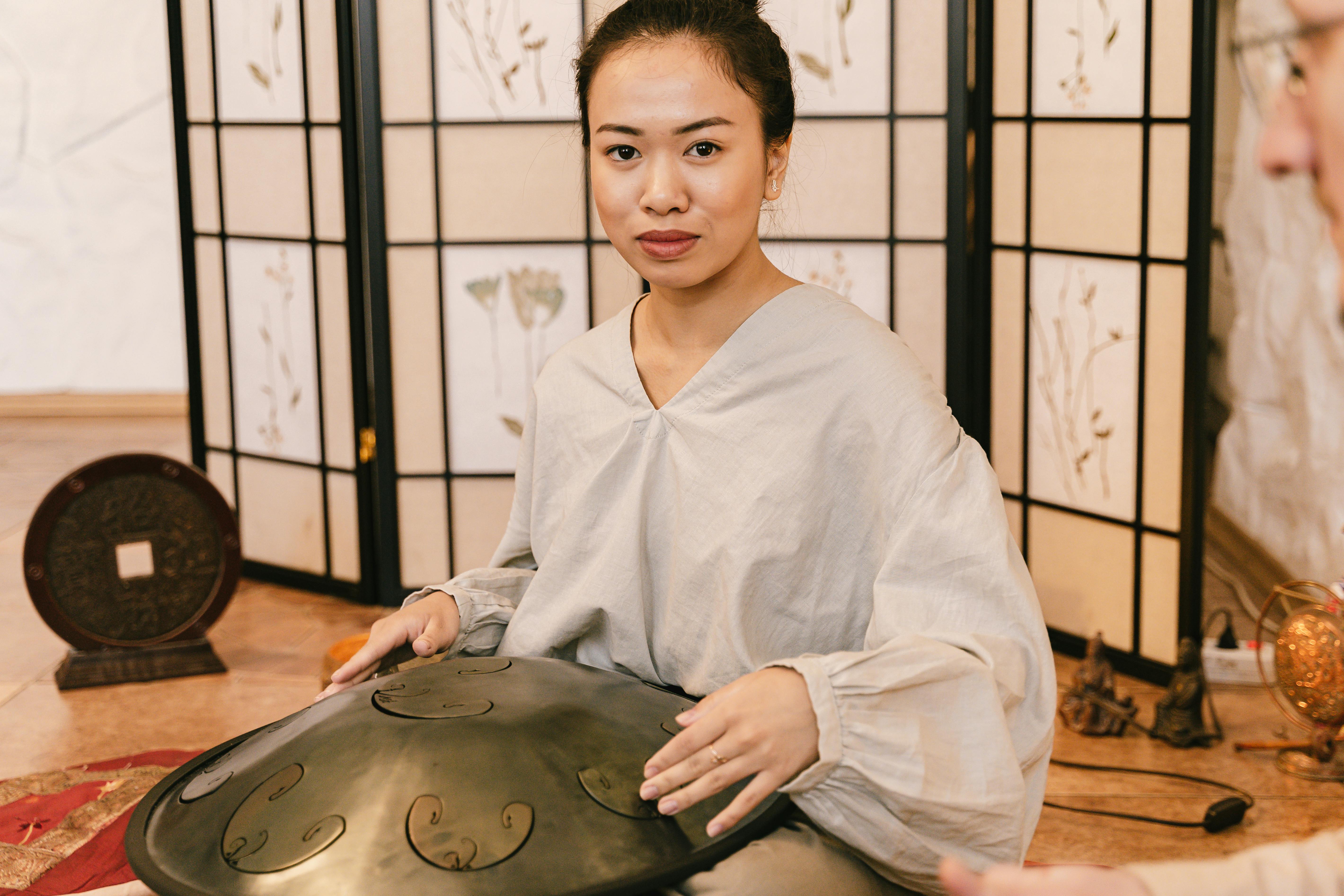 A Woman Using a Handpan