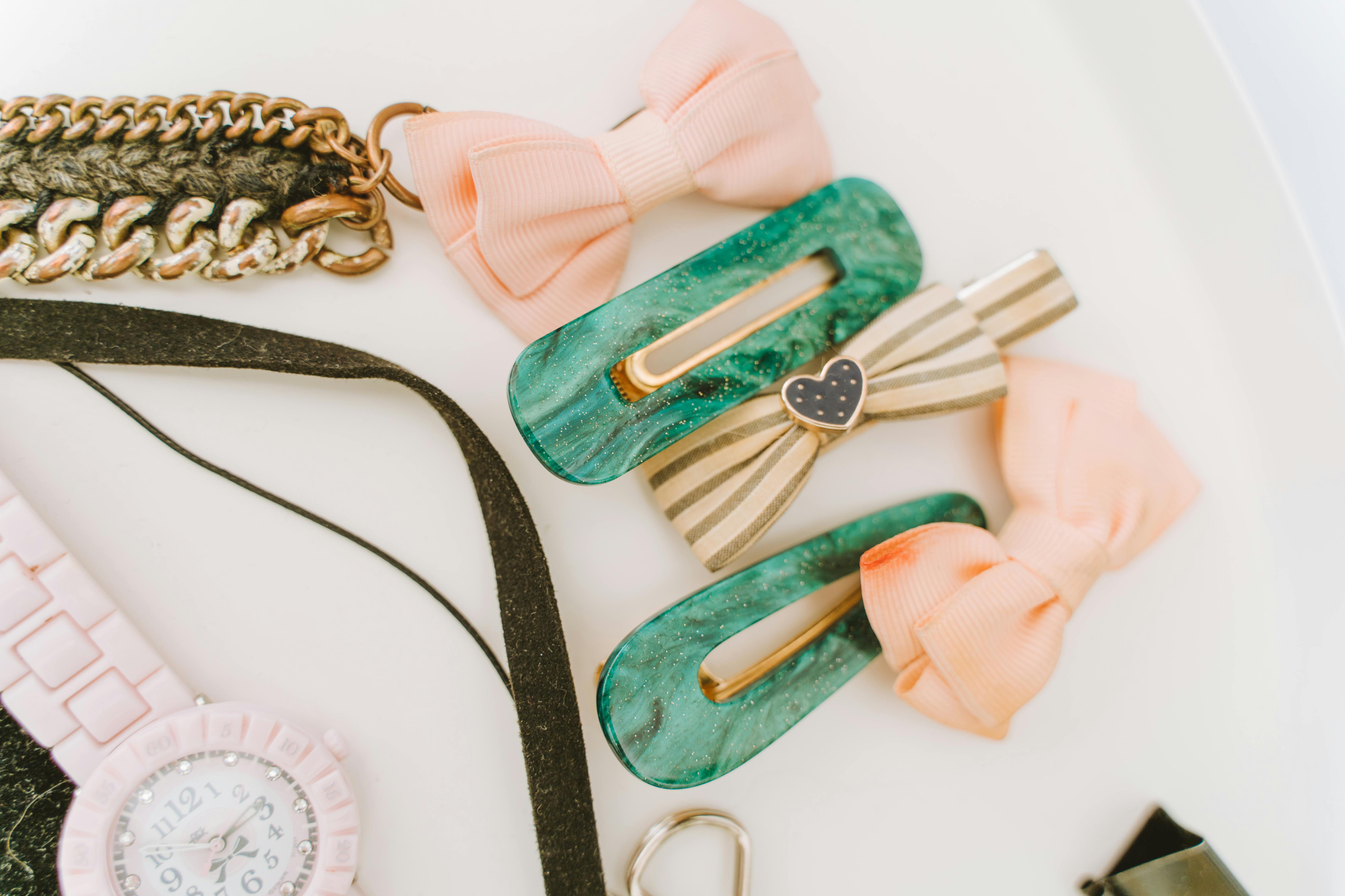 Hair Clips and Wristwatch on a White Surface