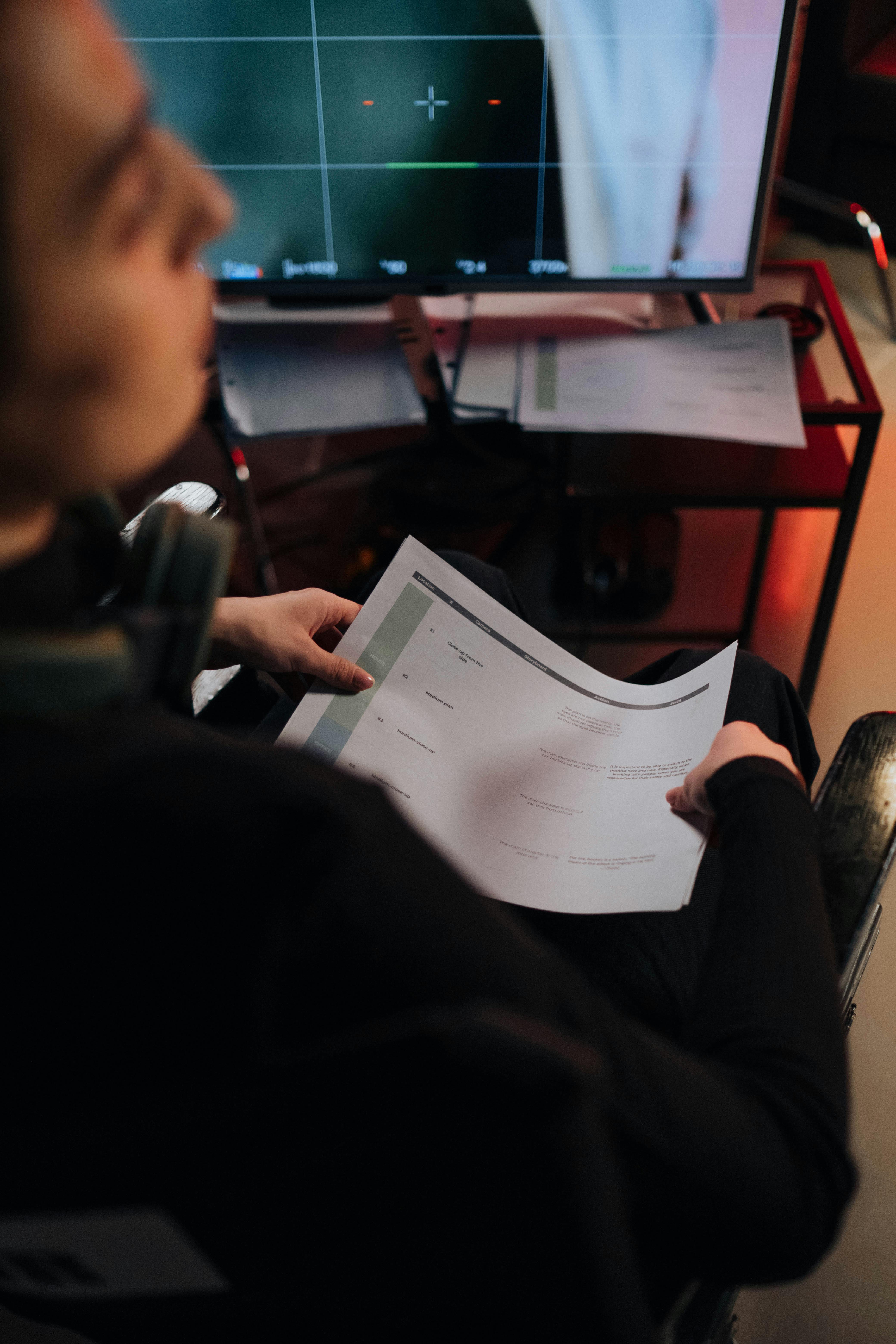 Person in Black Long Sleeve Holding a Paper 