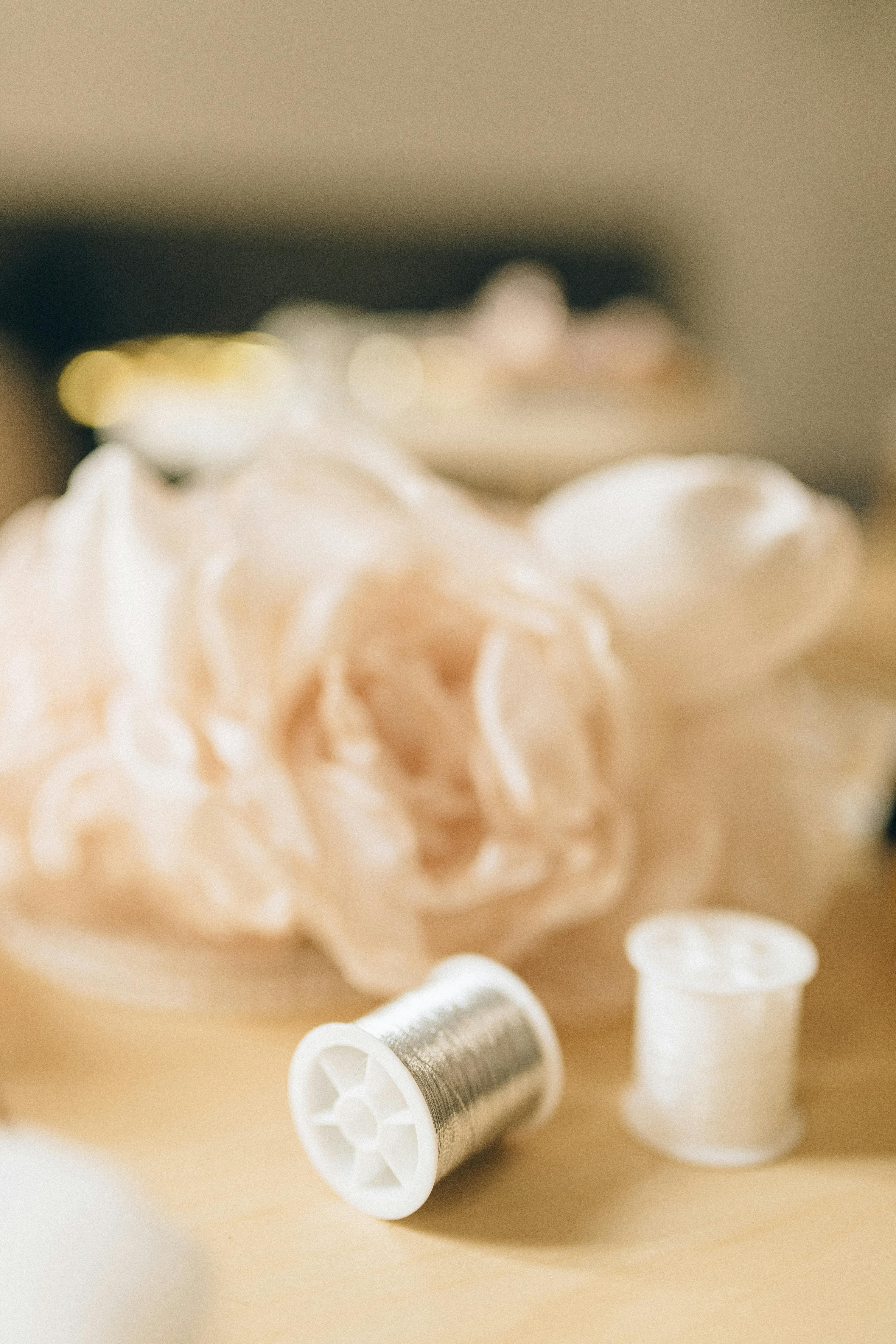 White Plastic Bottle Beside White Ceramic Figurine