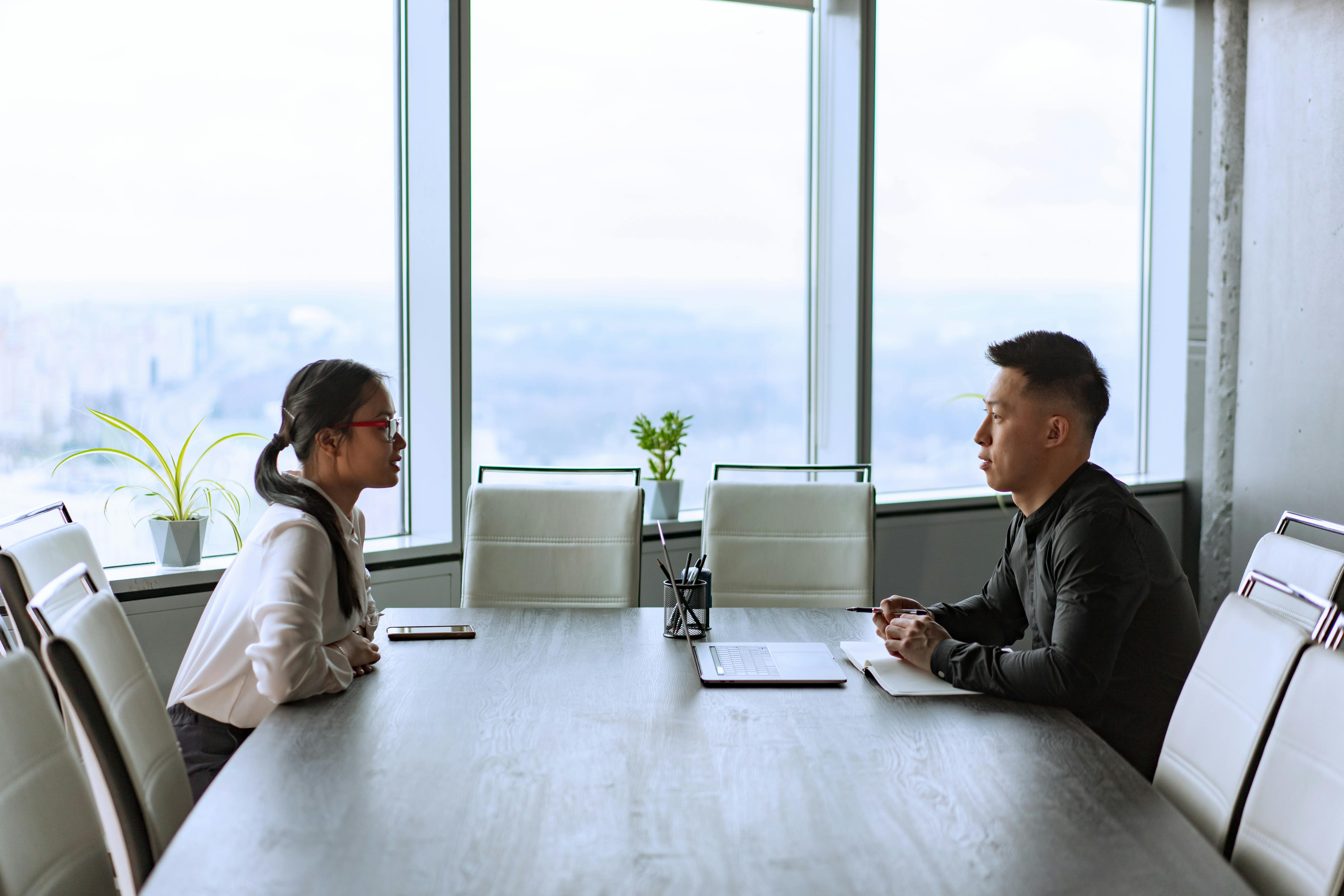 Man and Woman Sitting Face to Face