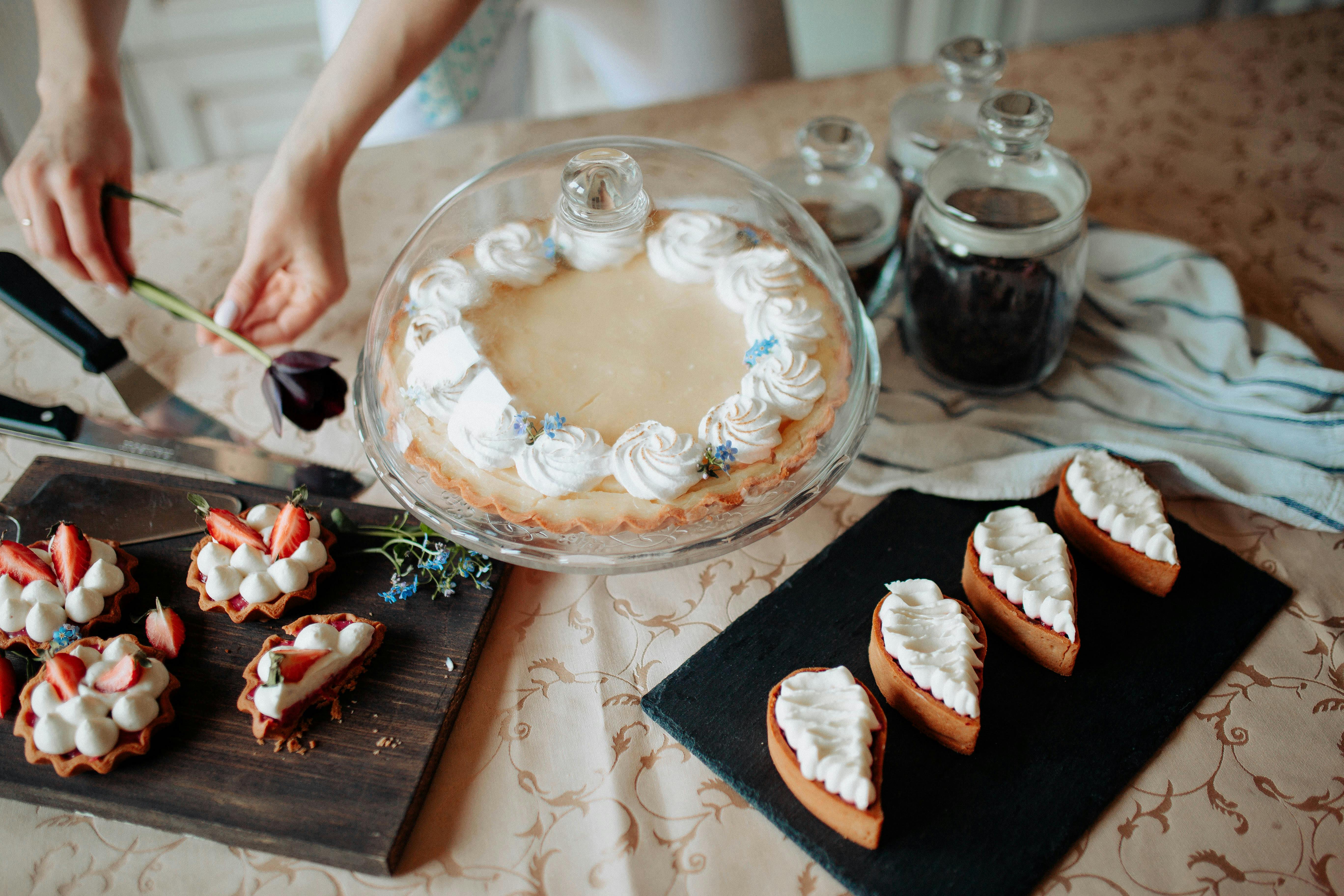 Crop woman with various delicious cakes