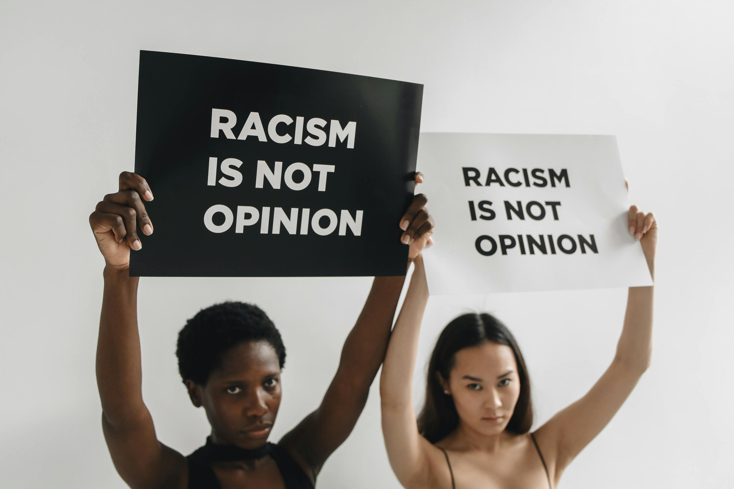 Women Holding Banners with a Statement