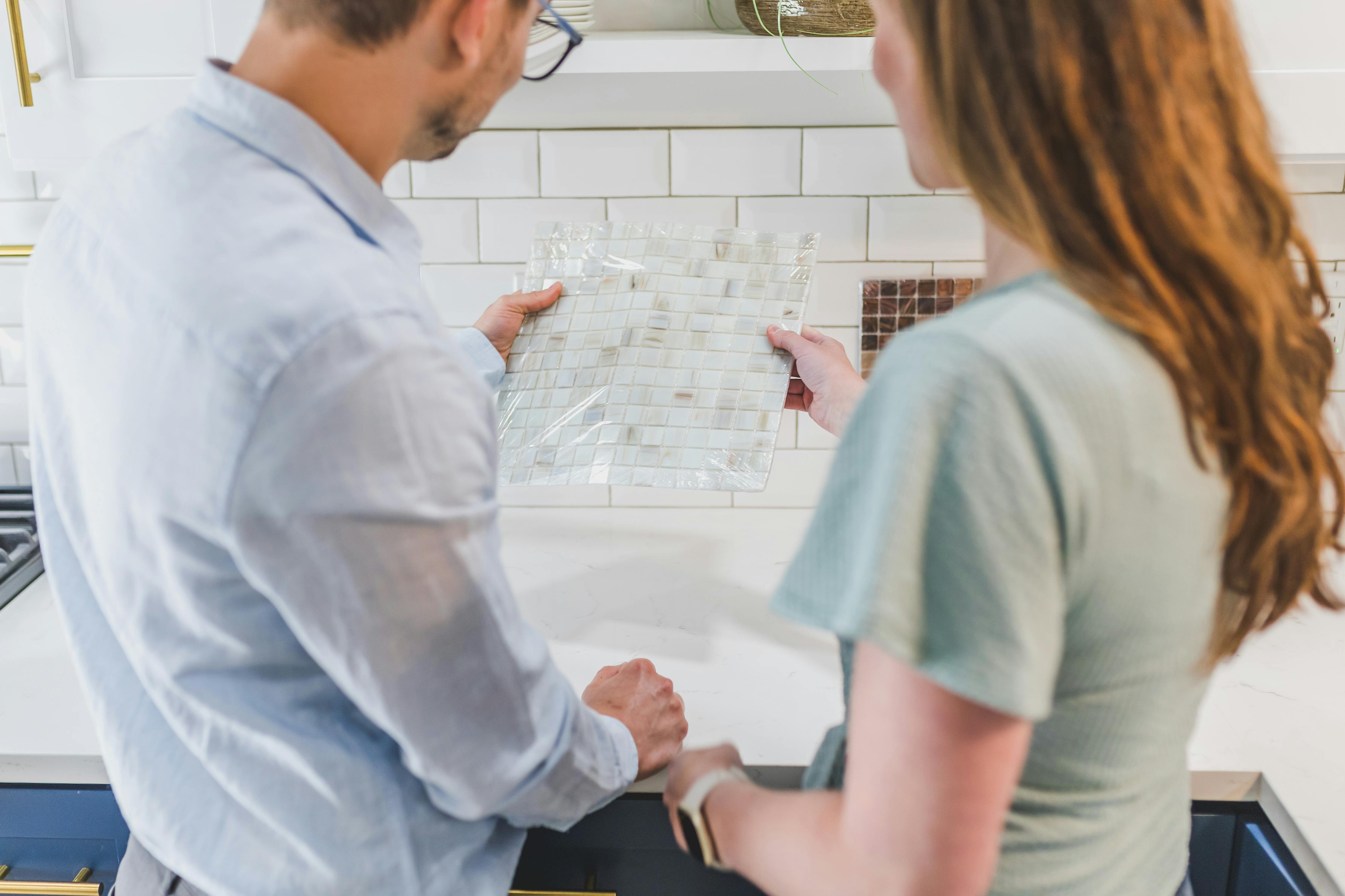 Man and Woman Looking at Tile Designs