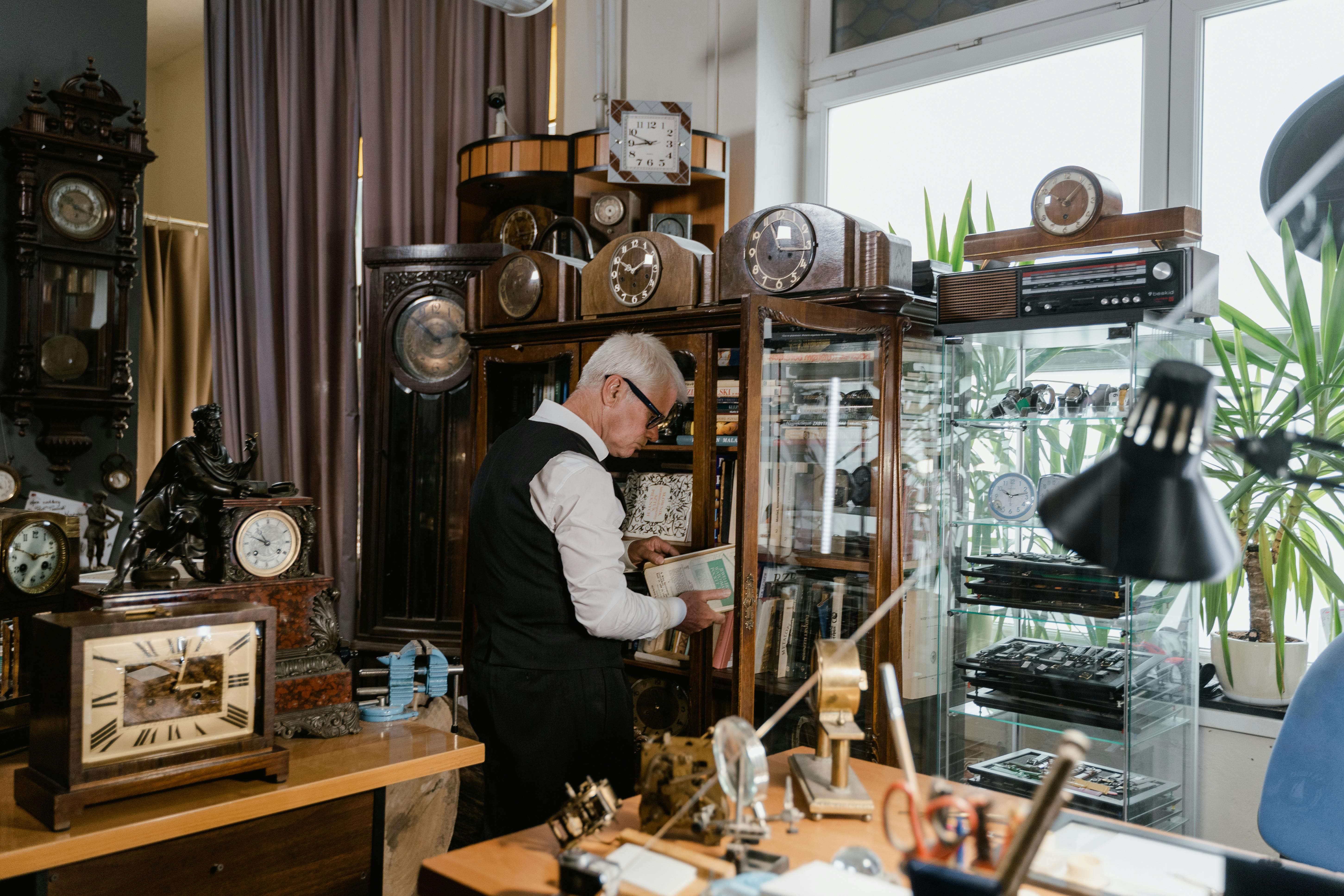 Man in an Antique Store with Vintage Clocks and Radios
