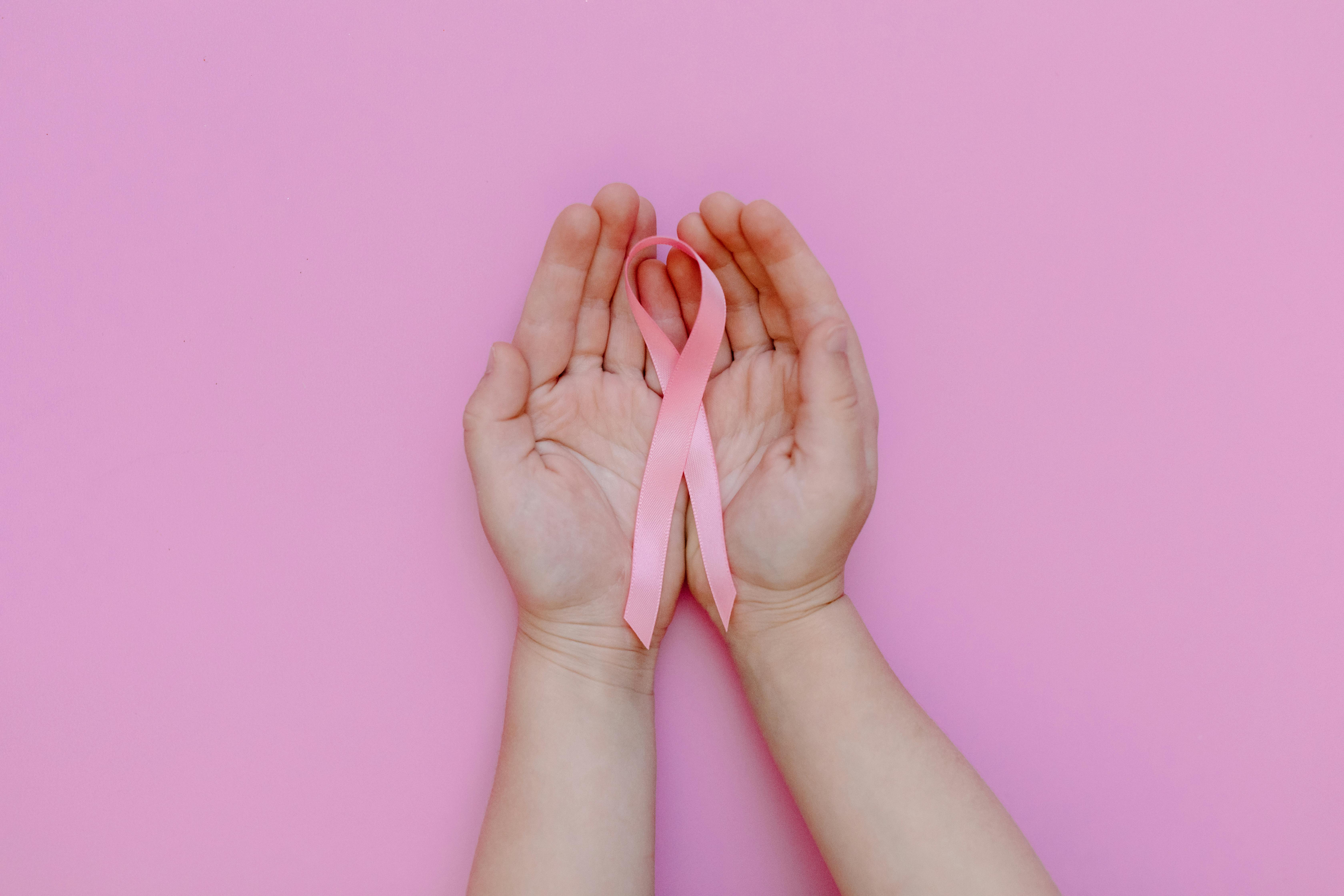 A Person Holding a Pink Ribbon